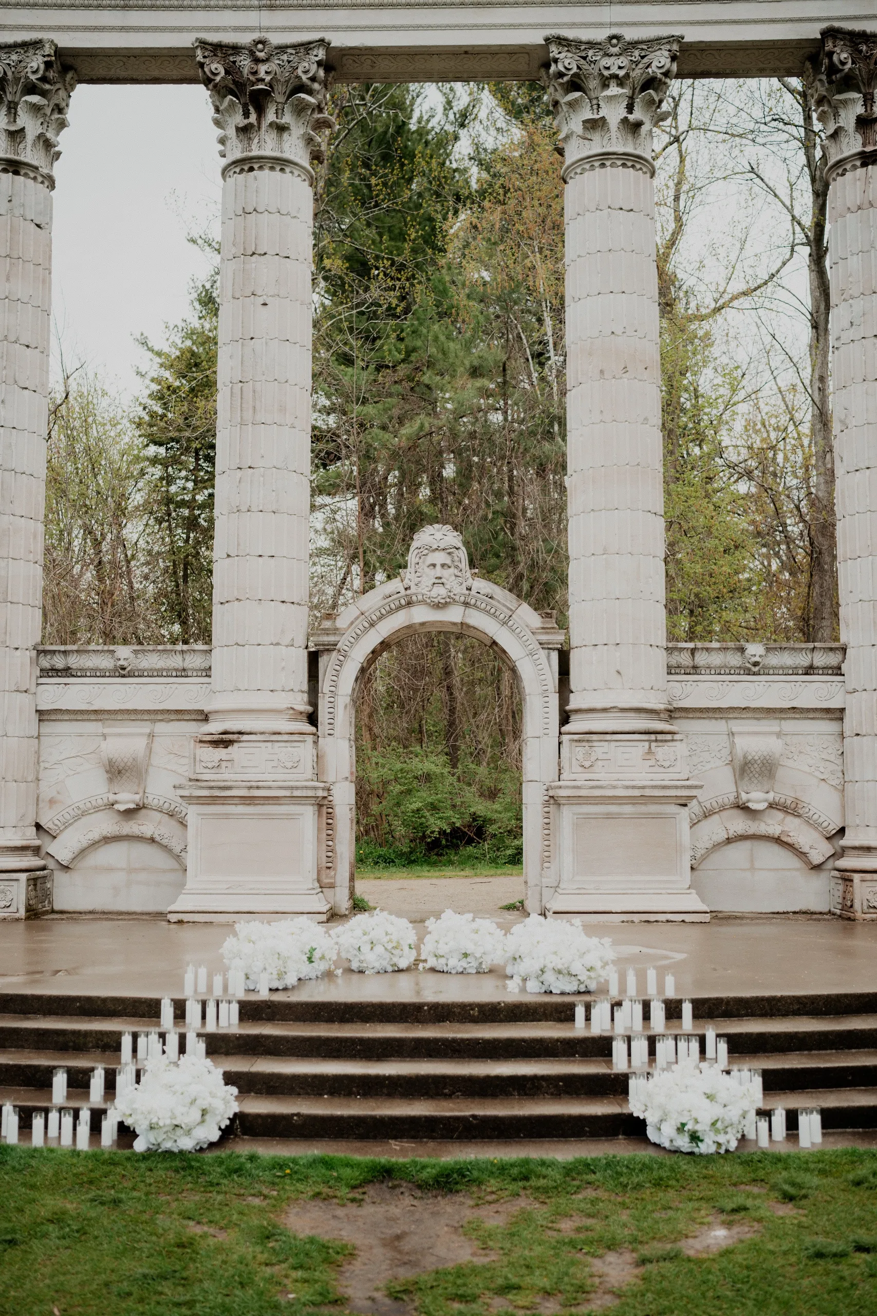 The Greek theatre colonnade at Guild Park and Gardens, set with white florals and pillar candles, by AD Photography