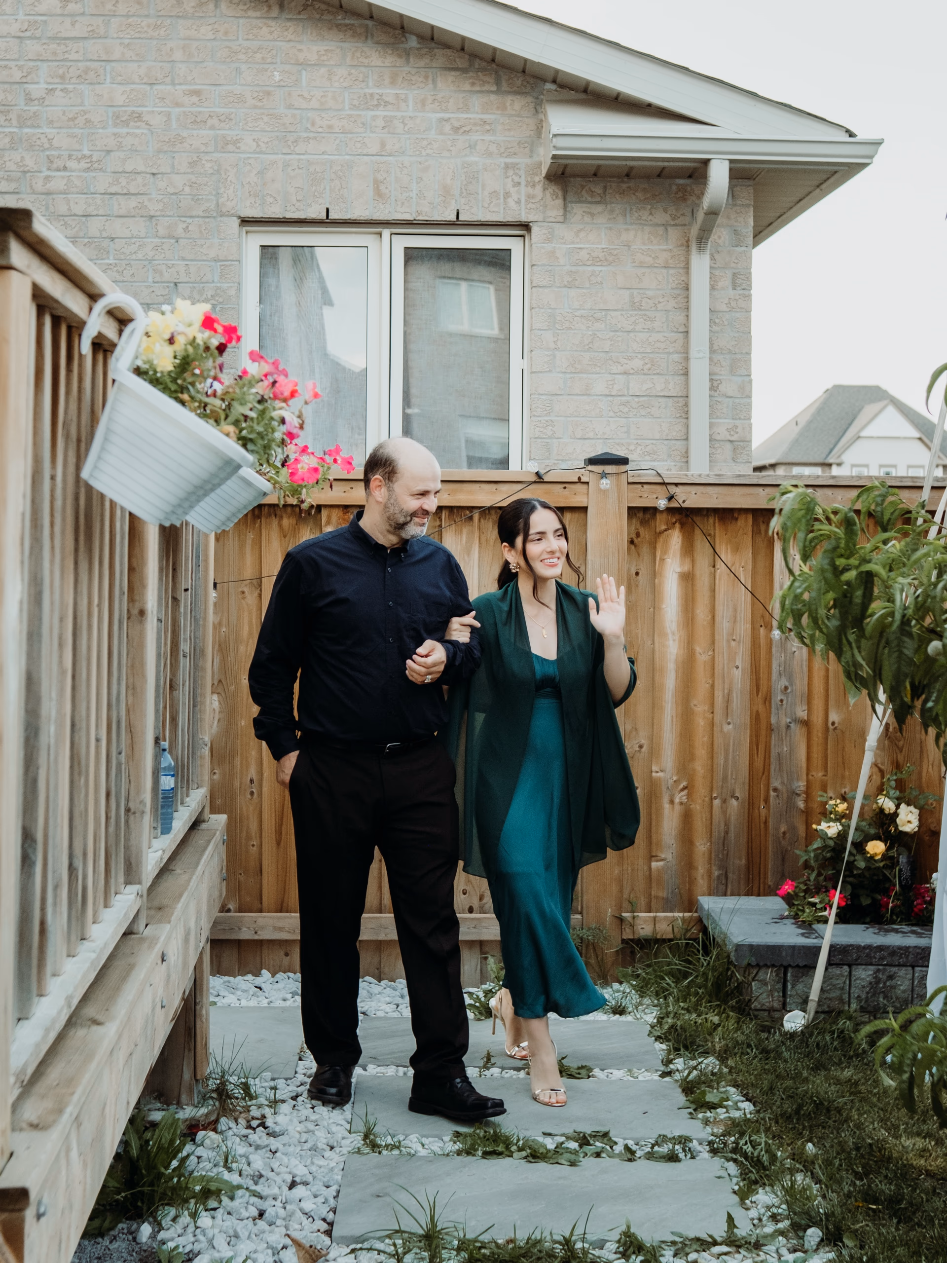 A backyard wedding at a Toronto family home, cedar fence strung with warm bulbs and a gazebo ceremony canopy at golden hour, by AD Photography