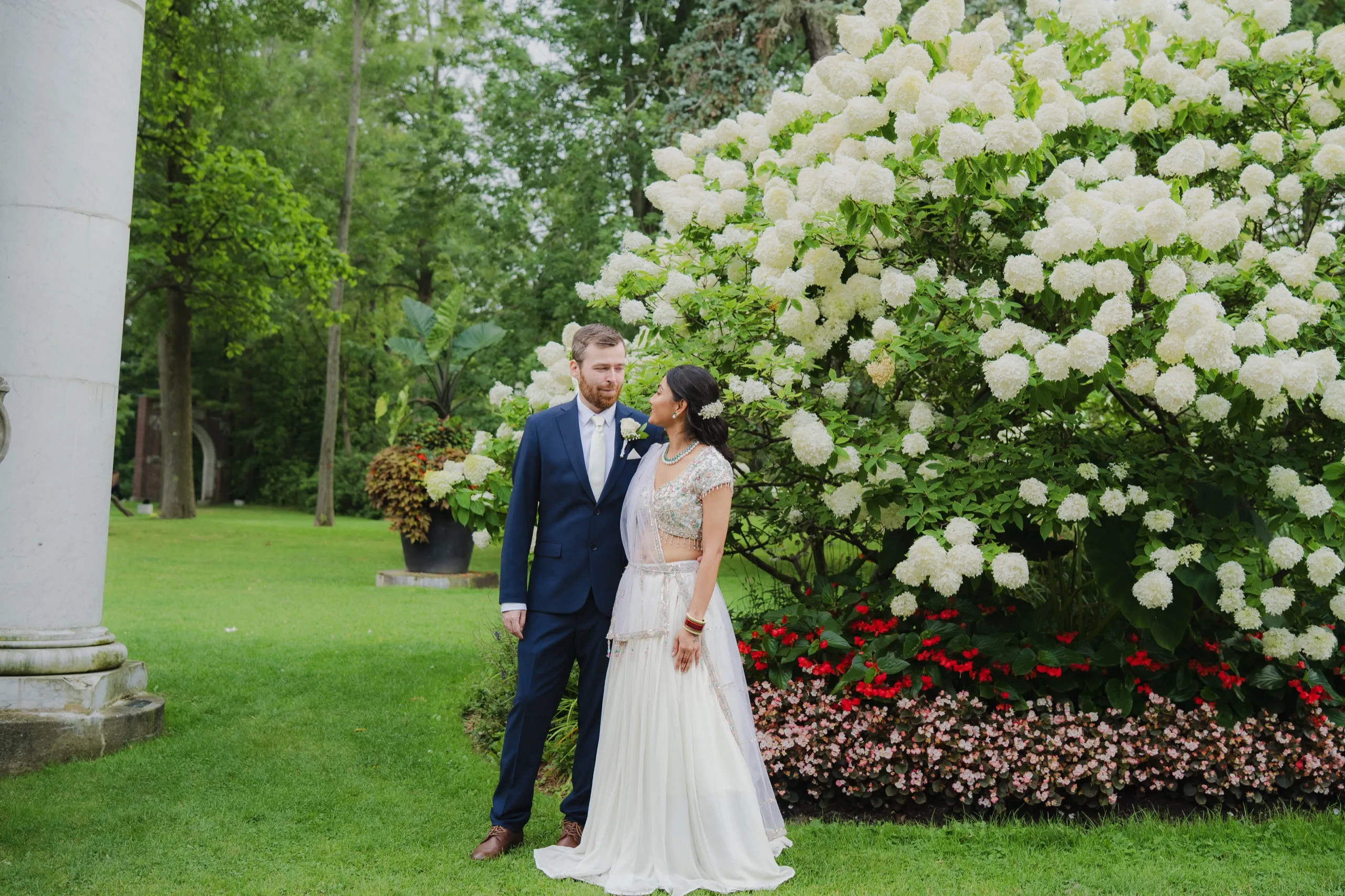 Derek and Nidhi share a quiet moment beside a blooming hydrangea in the Scarborough garden., by AD Photography