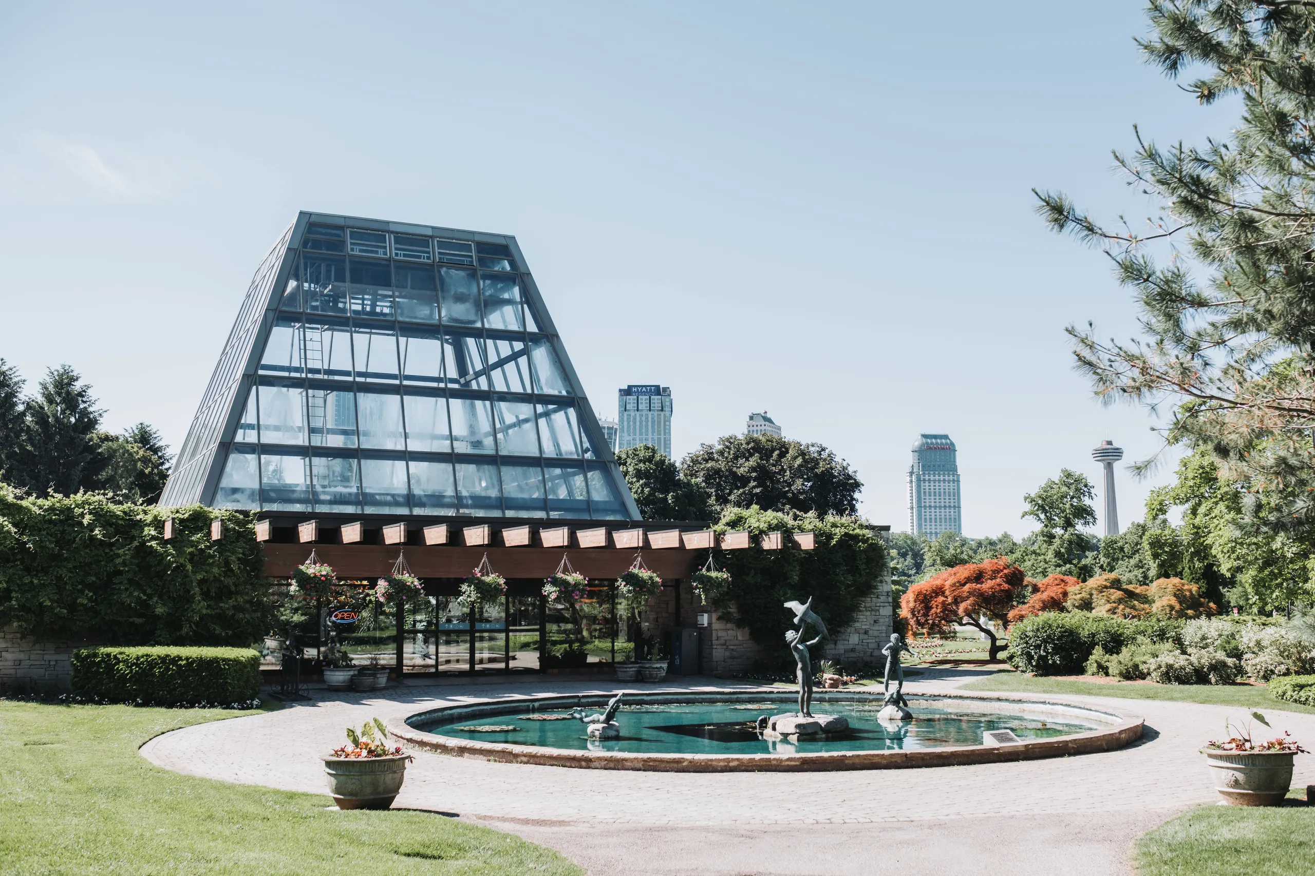 The glass conservatory and stone fountain courtyard at the Niagara Parks Botanical Gardens in Niagara Falls, by AD Photography
