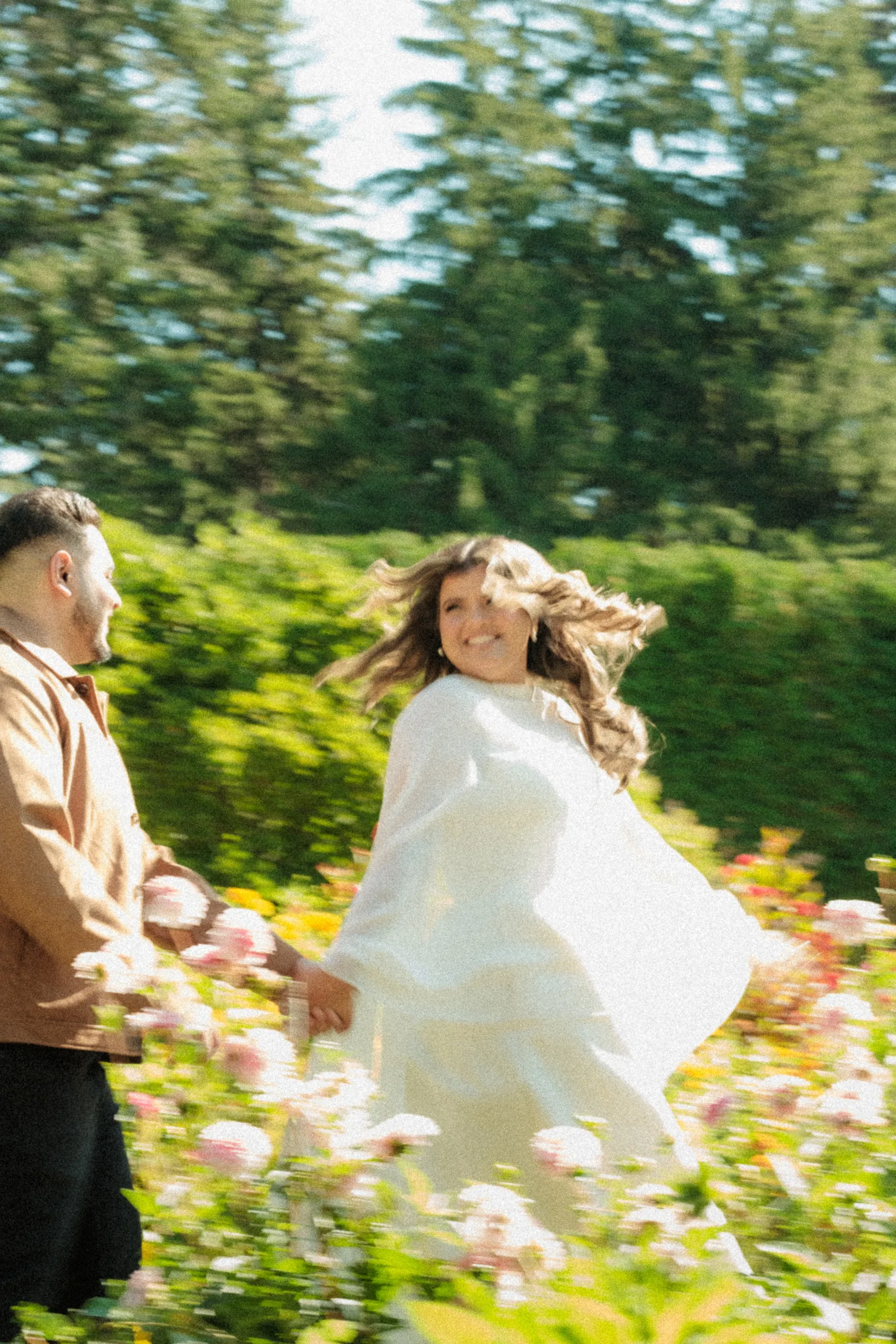 Parneet twirls through the rose beds at Parkwood Estate in Oshawa, hair and cape flying, by AD Photography