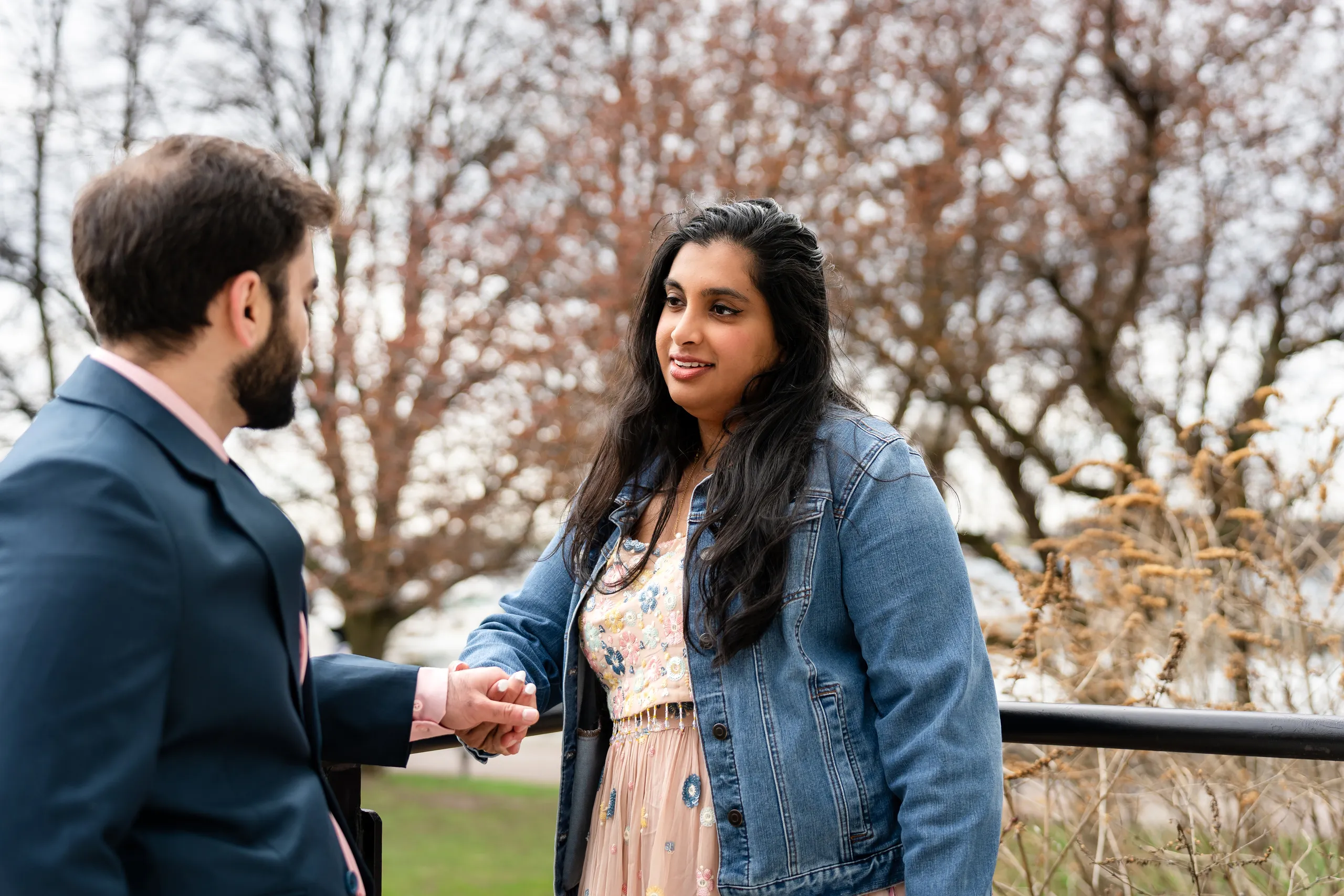 Abdullah and Nadia talk hand in hand along the Harbourfront railing at Toronto Music Garden, by AD Photography