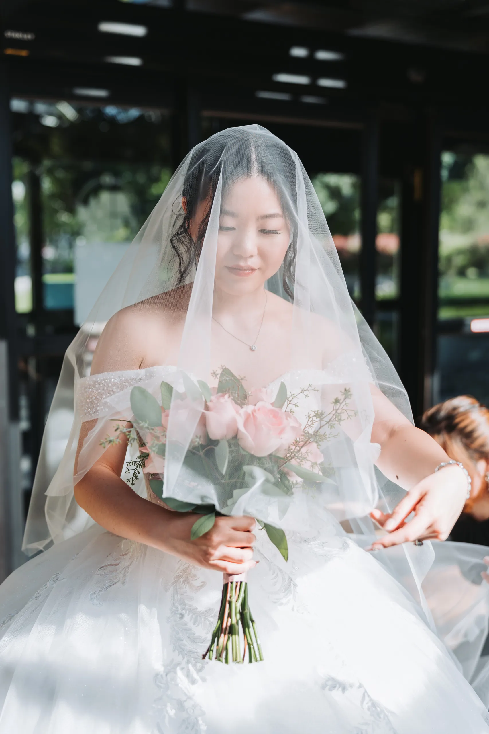 Karen with her cathedral veil draped over both shoulders before her Botanical Gardens wedding in Niagara Falls, by AD Photography