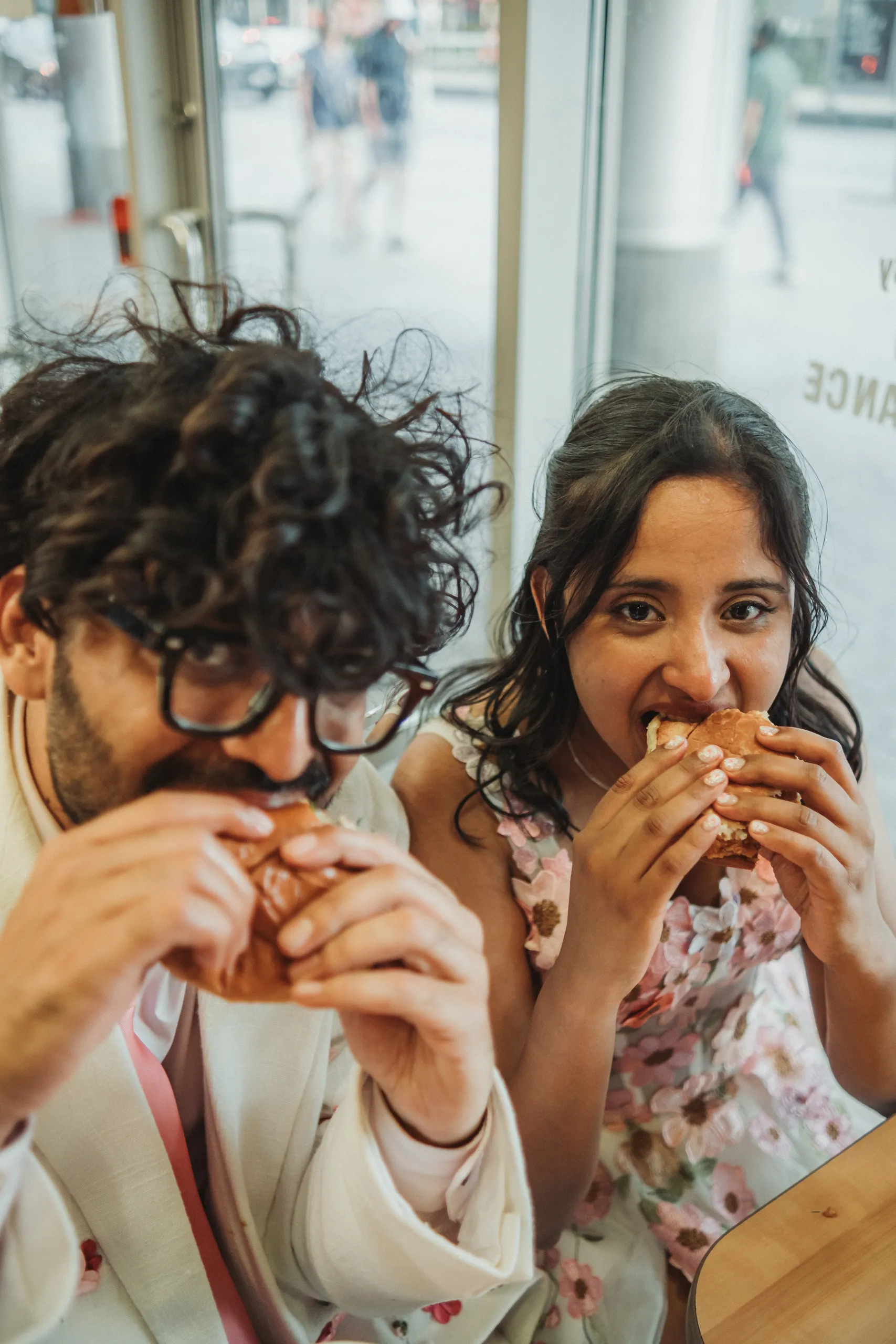 Harsh and Payal sharing a meal in a restaurant booth on their civil ceremony day in Toronto, by AD Photography