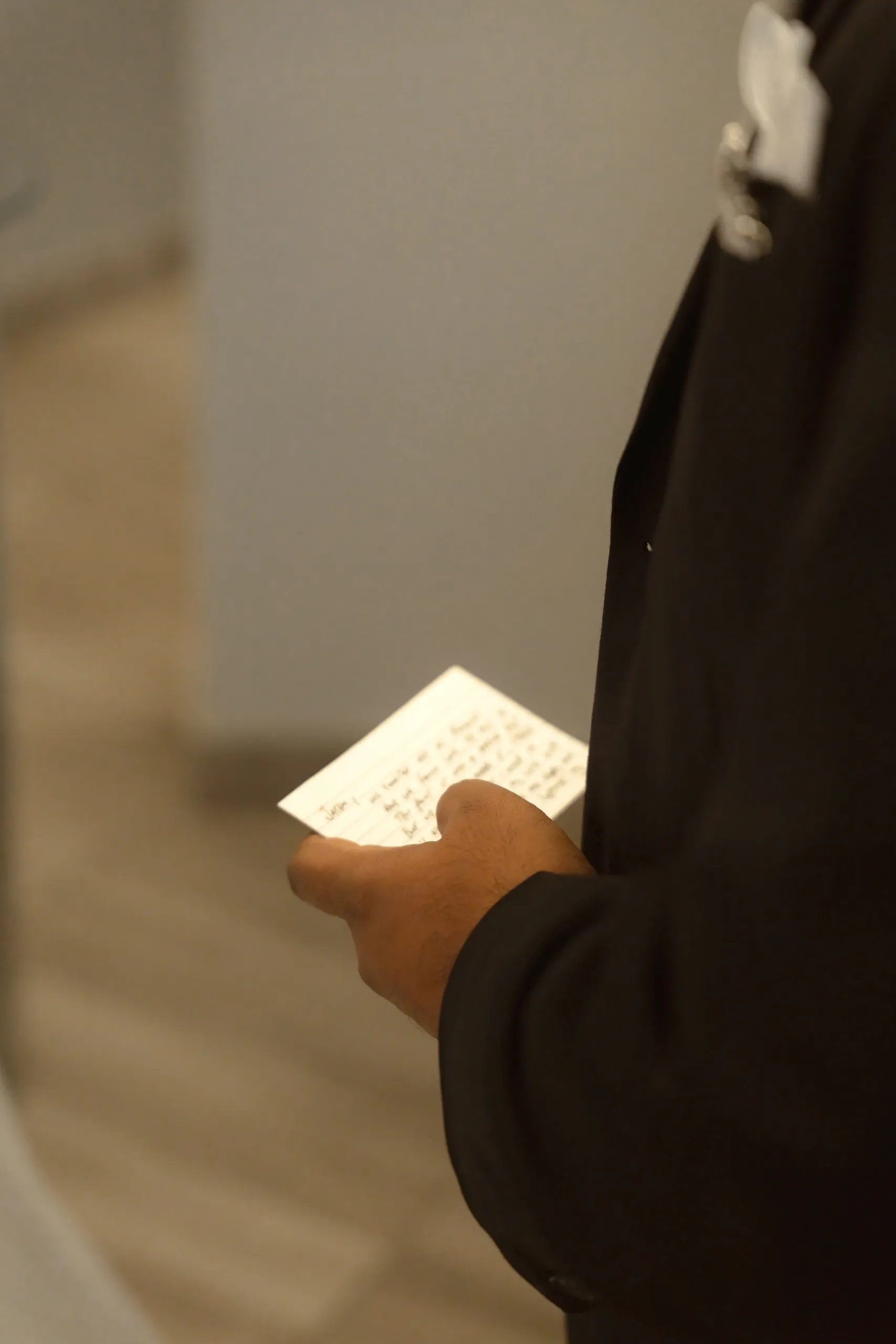 Groom holds his handwritten vows during the civil ceremony, by AD Photography