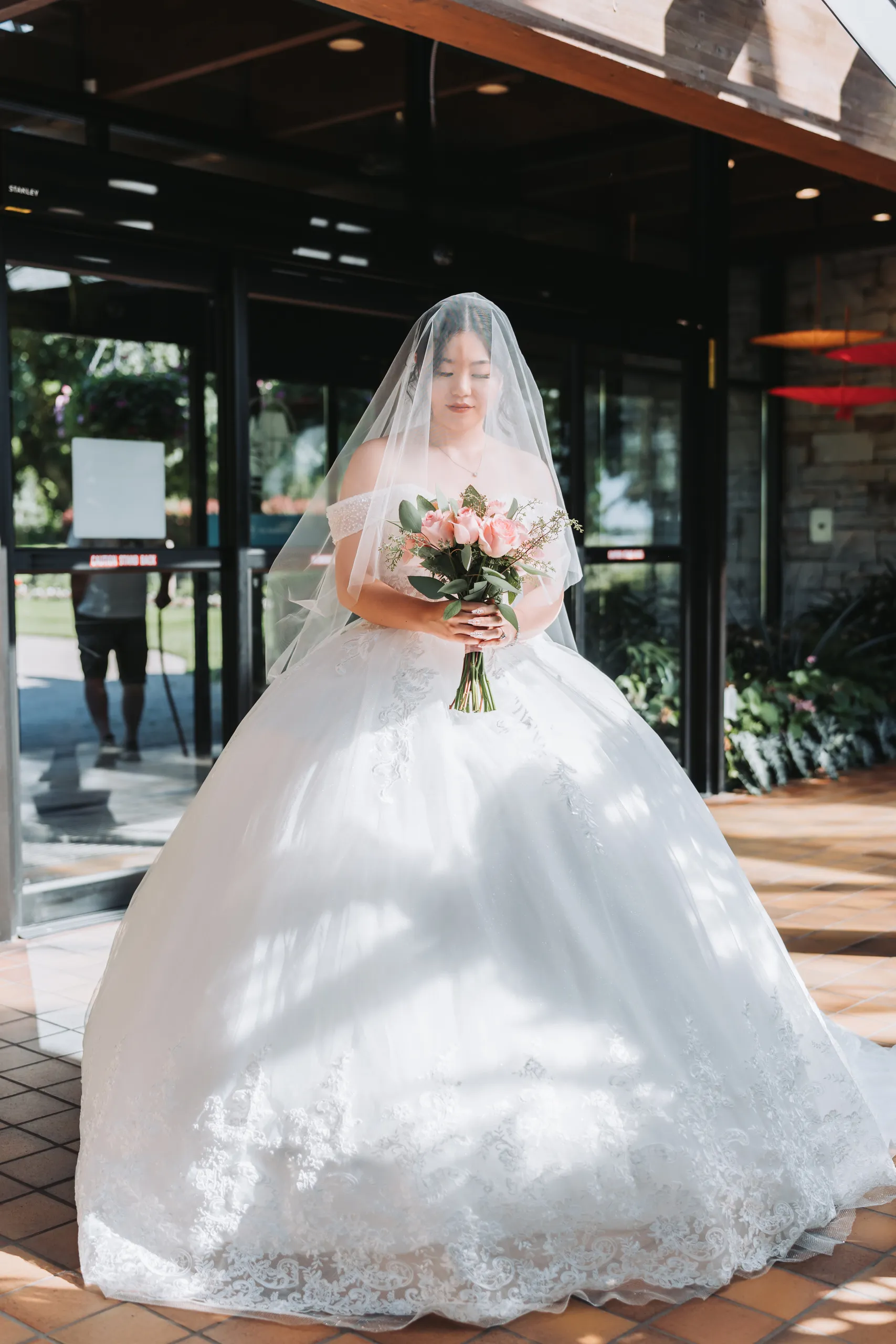 Full length bridal portrait of Karen in a lace ball gown at the Botanical Gardens archway, Niagara Falls, by AD Photography
