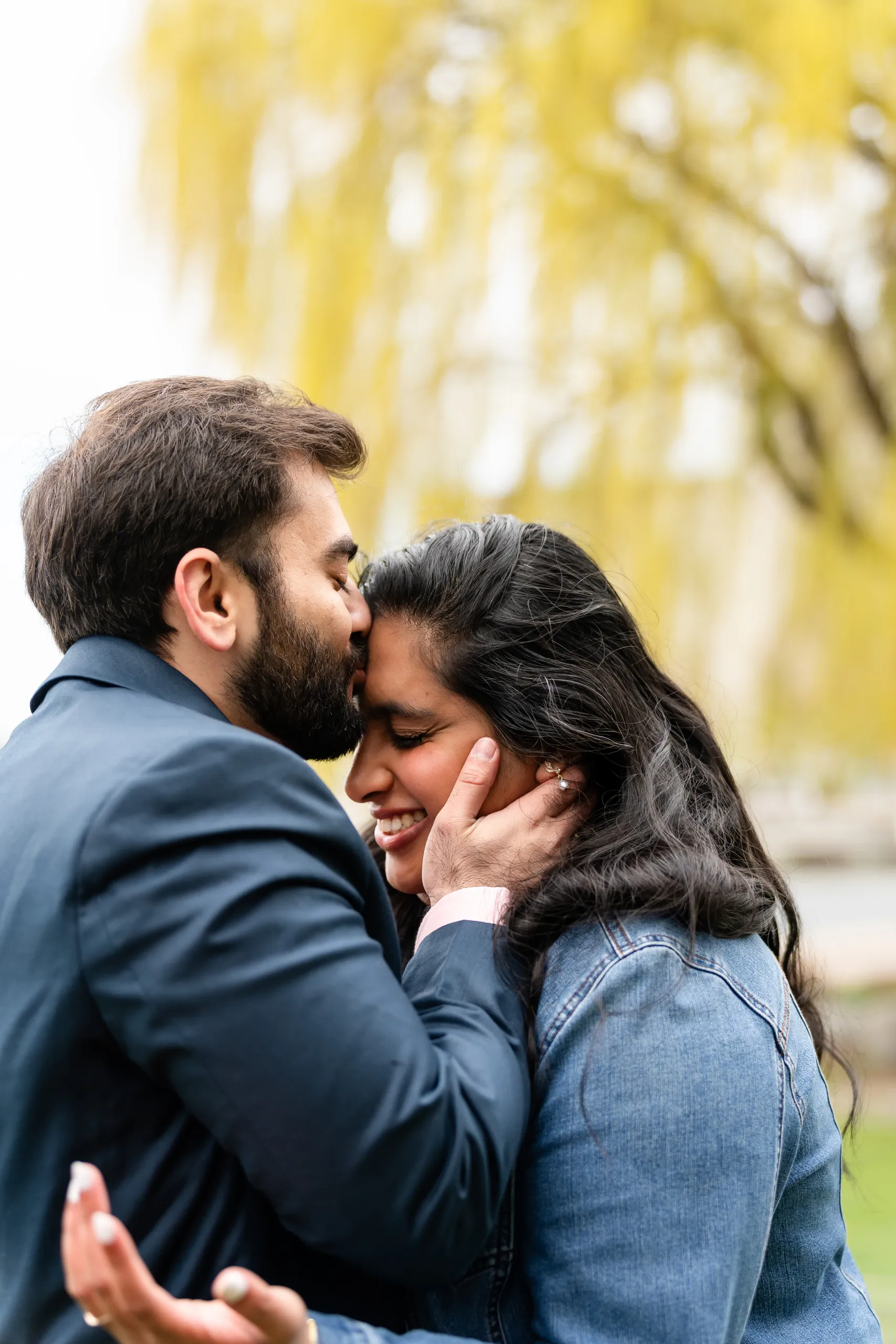 Abdullah kisses Nadia's forehead under the willow tree at their Toronto Music Garden civil ceremony, by AD Photography