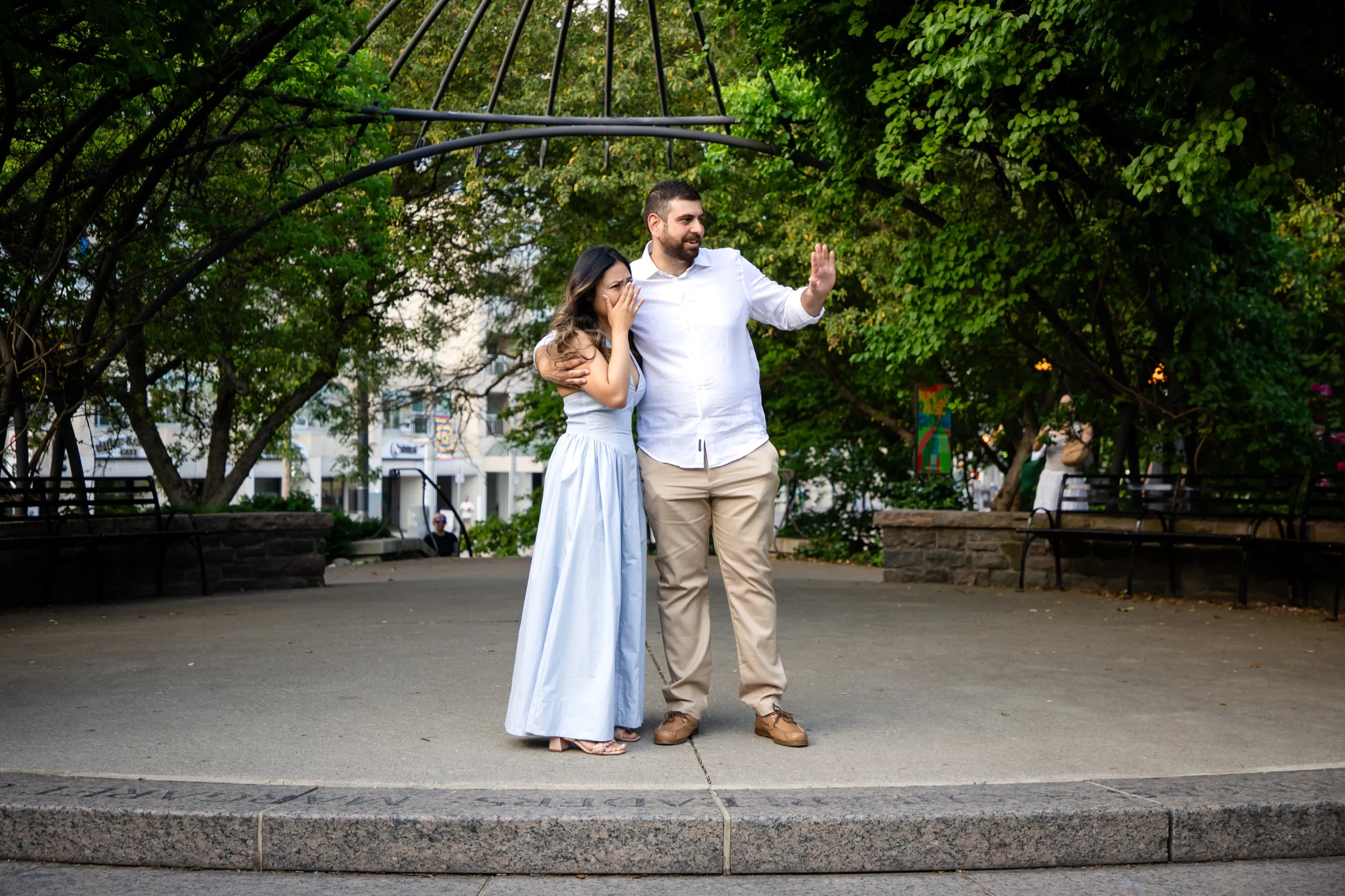 Margarita covering her face with both hands after saying yes at the Toronto Music Garden, by AD Photography