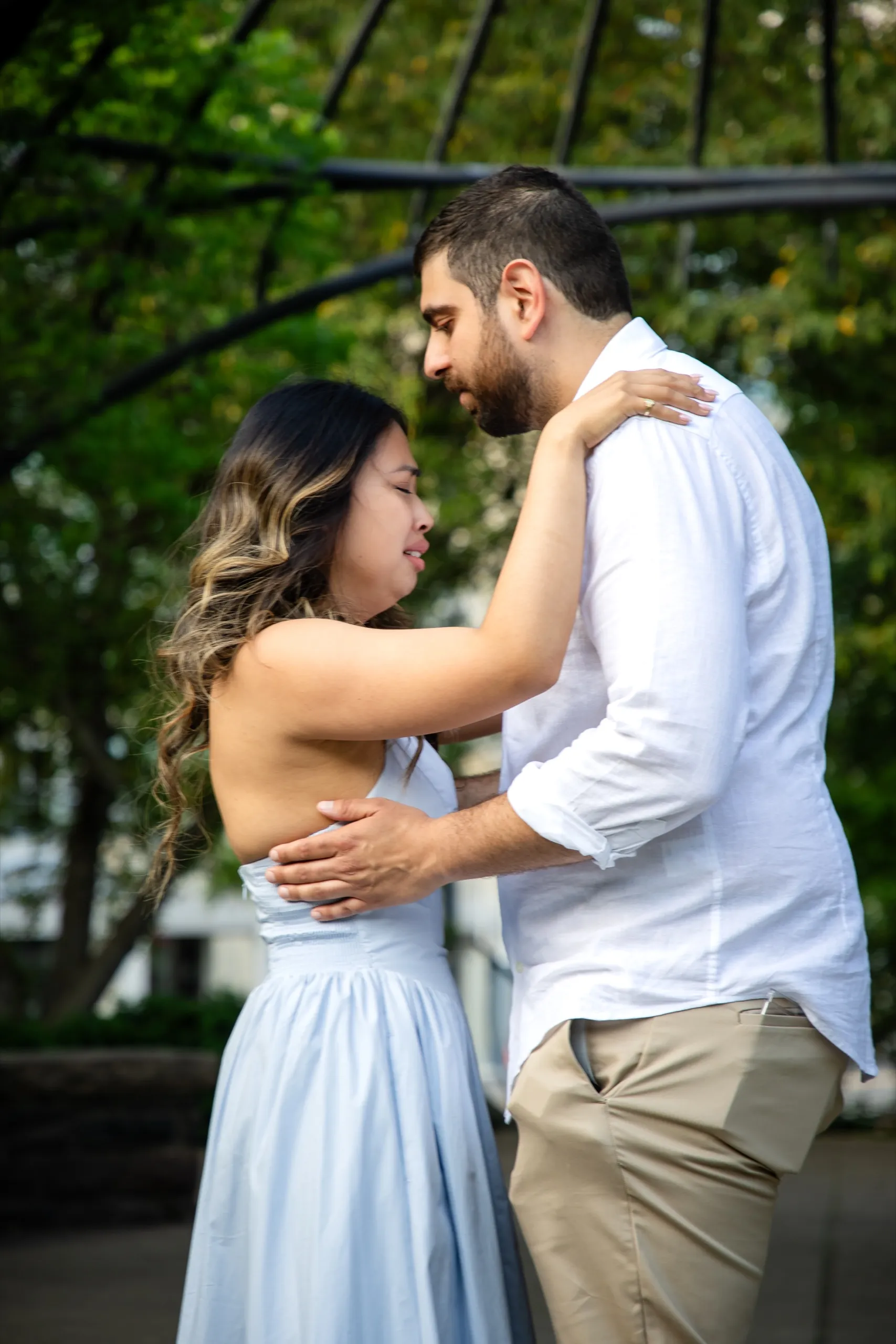 Margarita and Mike holding each other after the proposal at the Toronto Music Garden in Toronto, by AD Photography