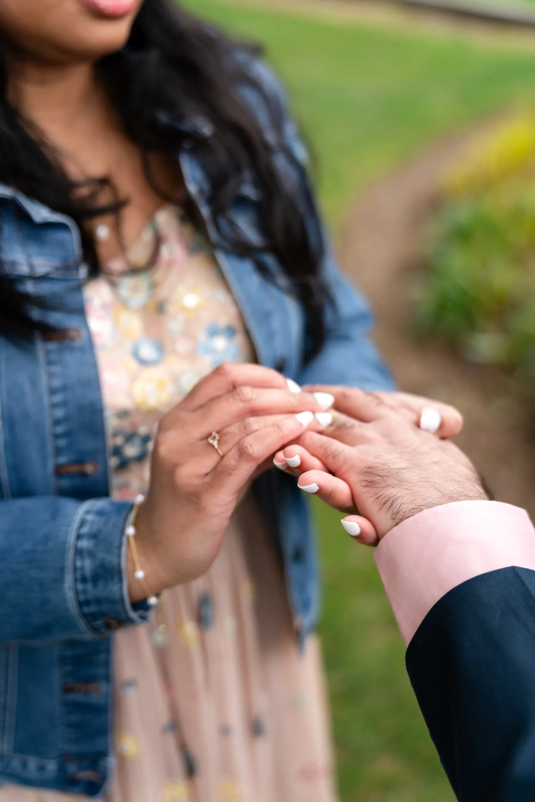 Close up of the wedding ring placed on Nadia's hand at Toronto Music Garden, by AD Photography