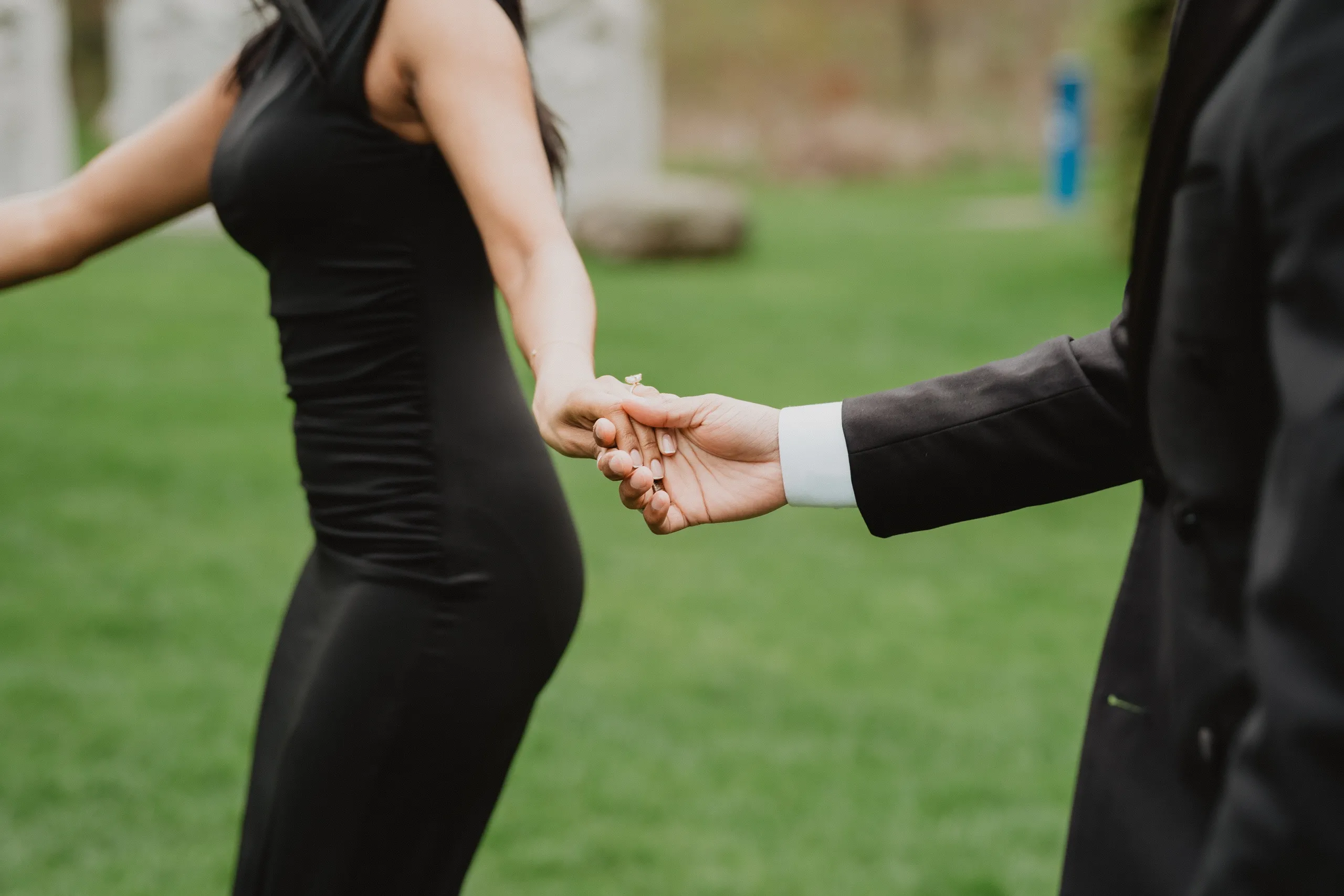 Their hands linked mid walk, Lavina's engagement ring catching the light at Guild Park and Gardens, by AD Photography