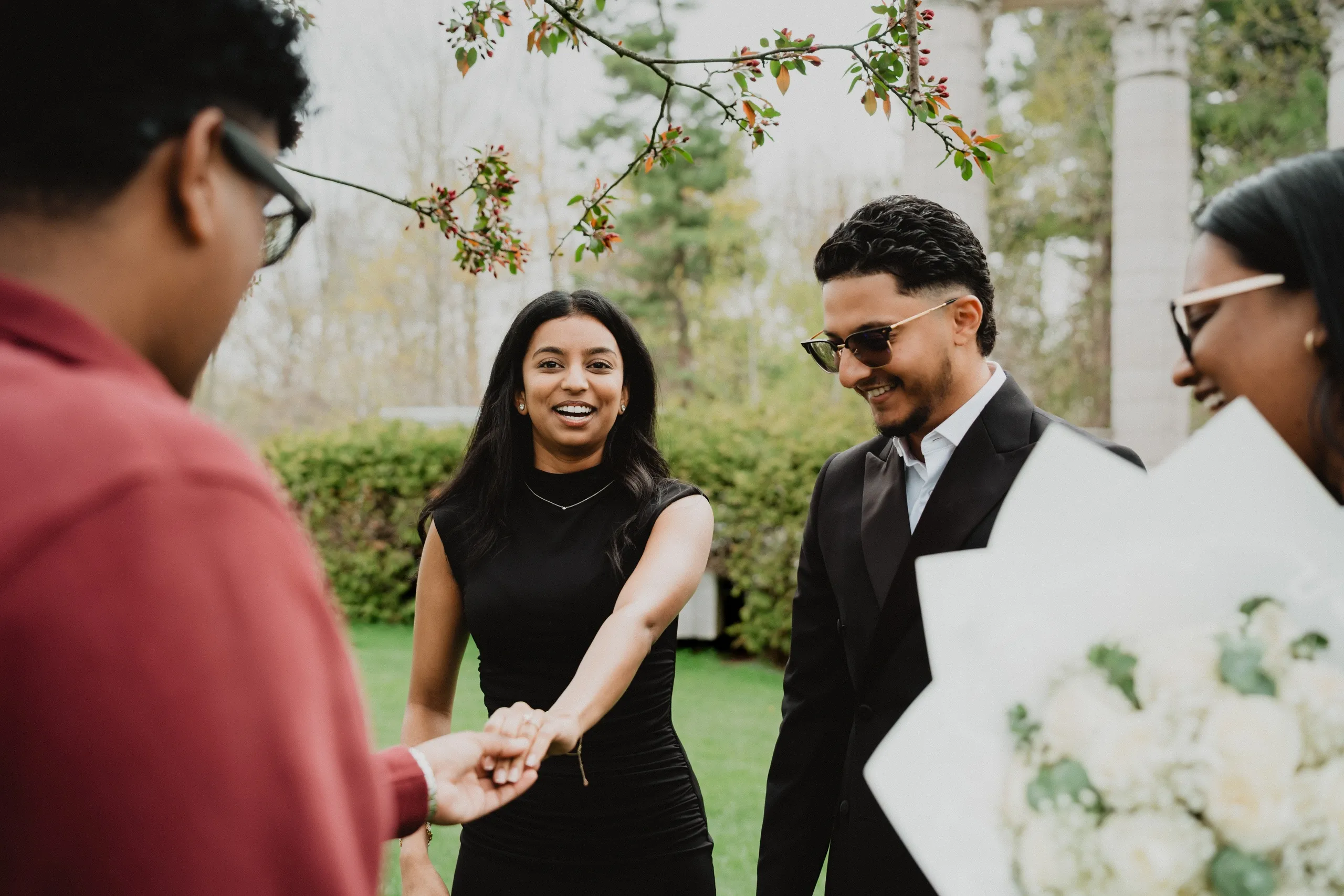 Lavina showing her ring to friends who gathered close after the proposal at Guild Park and Gardens, by AD Photography