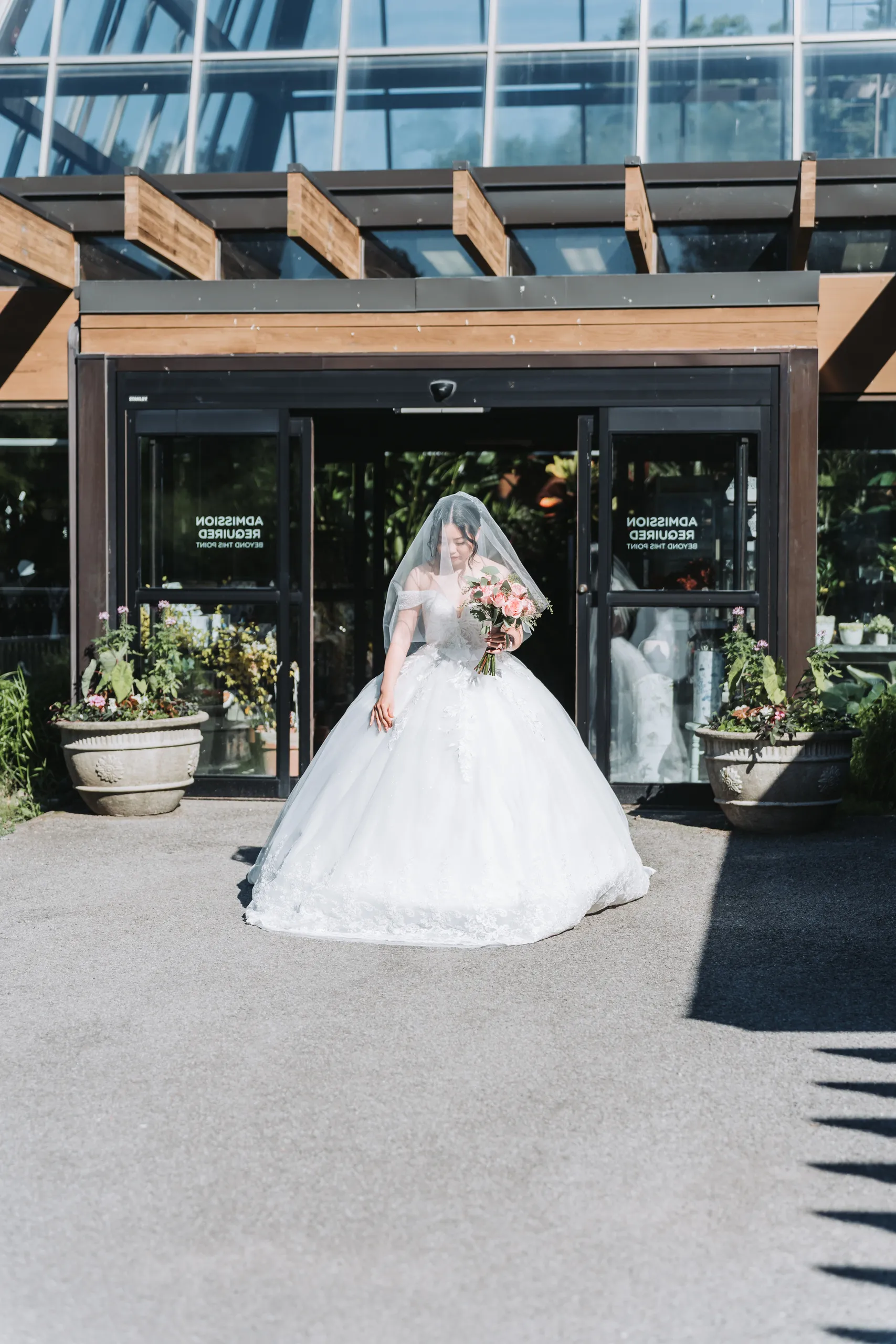 Karen framed in the symmetrical glass entrance of the Botanical Gardens conservatory, Niagara Falls, by AD Photography
