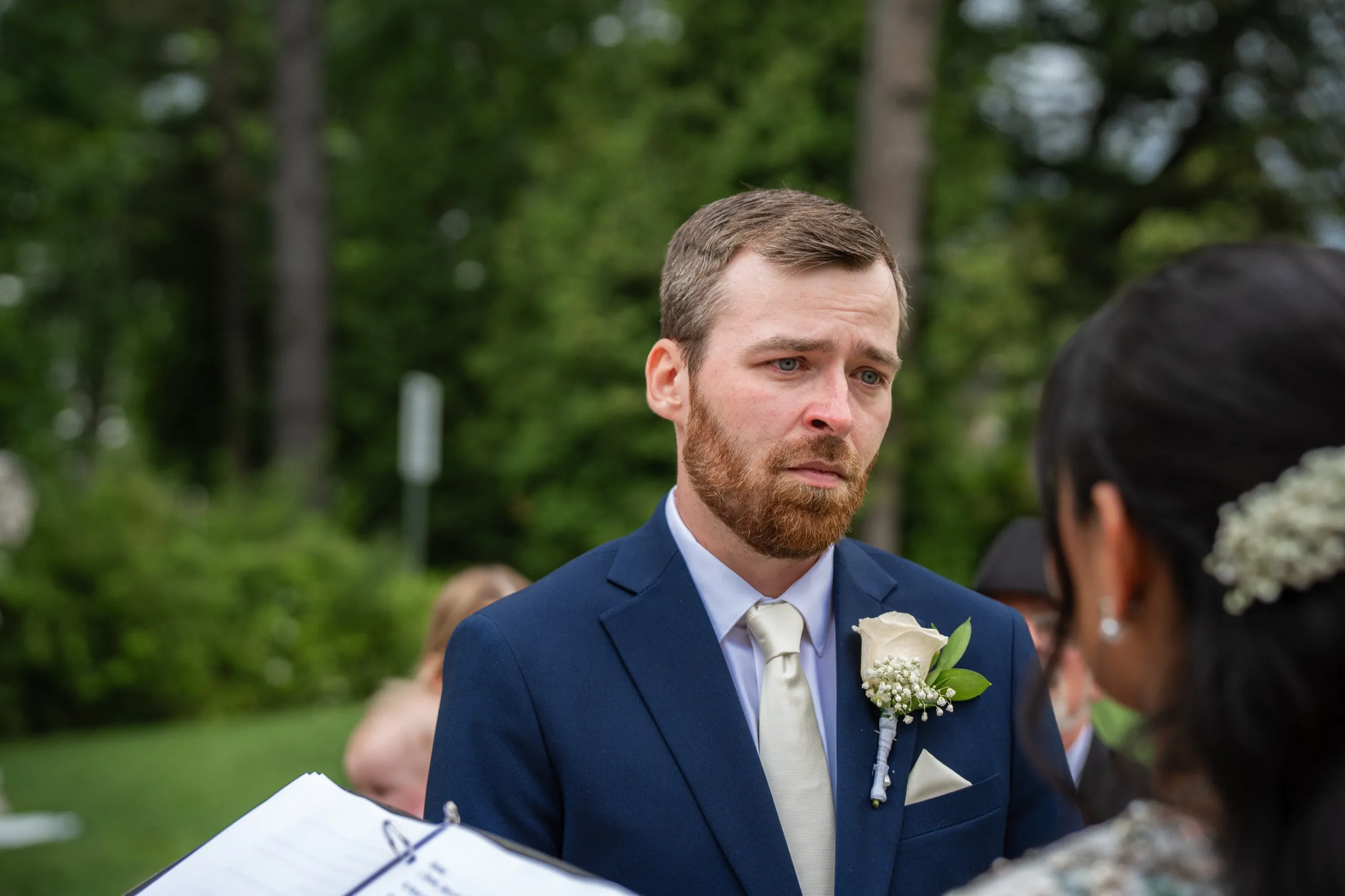Derek's eyes well up mid vow as Nidhi stands close, baby's breath tucked in her hair., by AD Photography