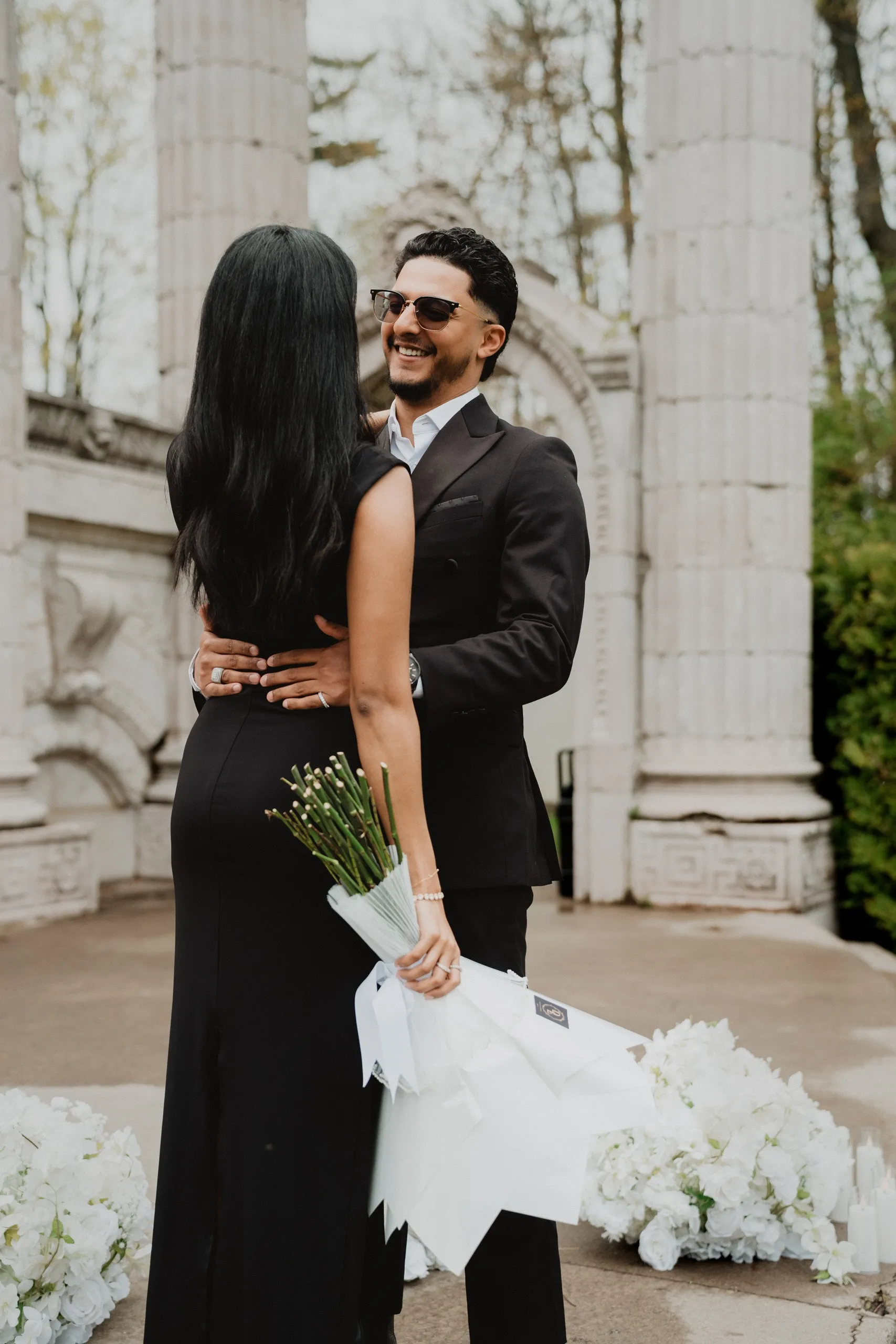 Raeed holding Lavina close after the proposal, her bouquet still upside down in her hand, by AD Photography