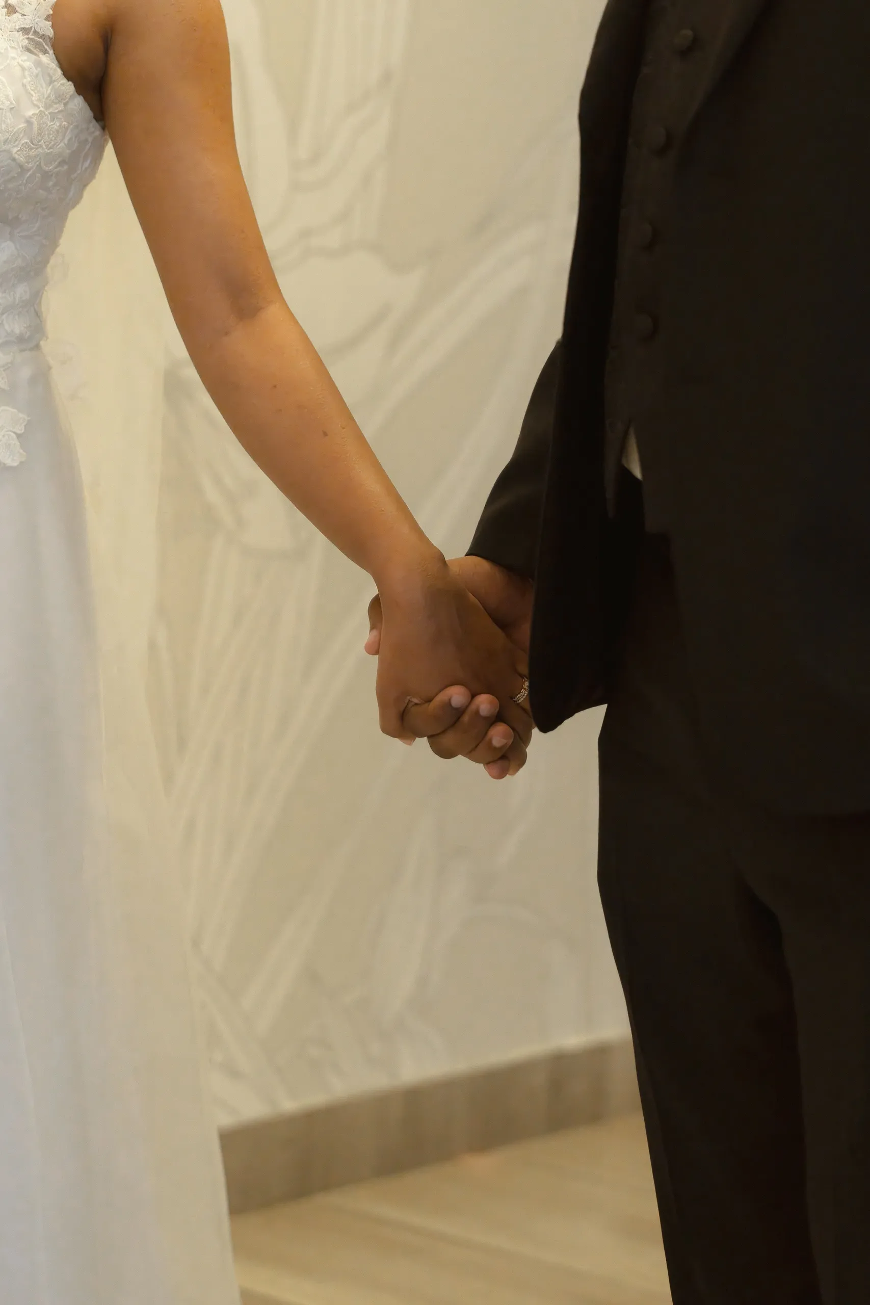 Bride and groom hold hands after the civil ceremony, by AD Photography