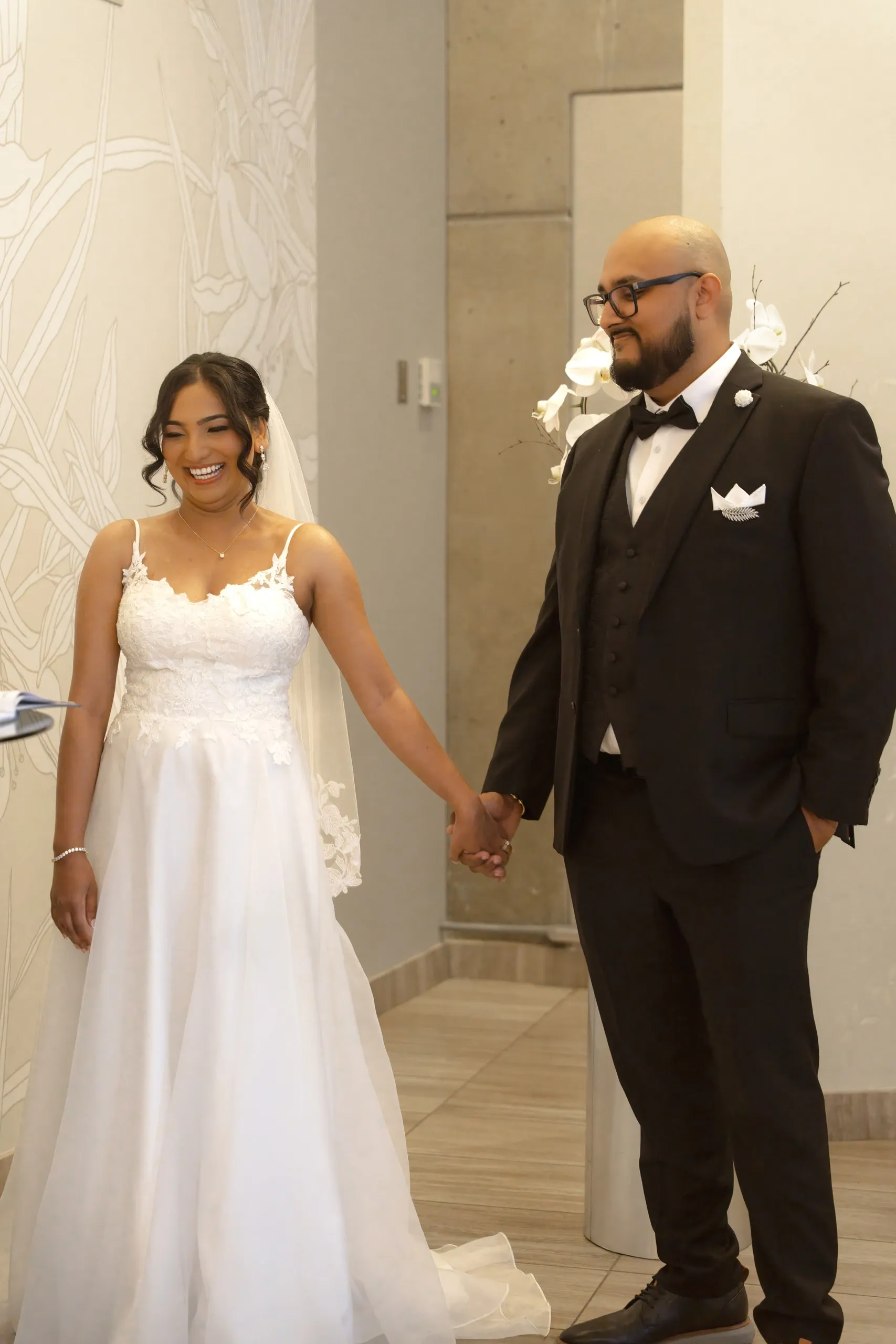 Newlyweds laugh together after signing at Toronto City Hall, by AD Photography