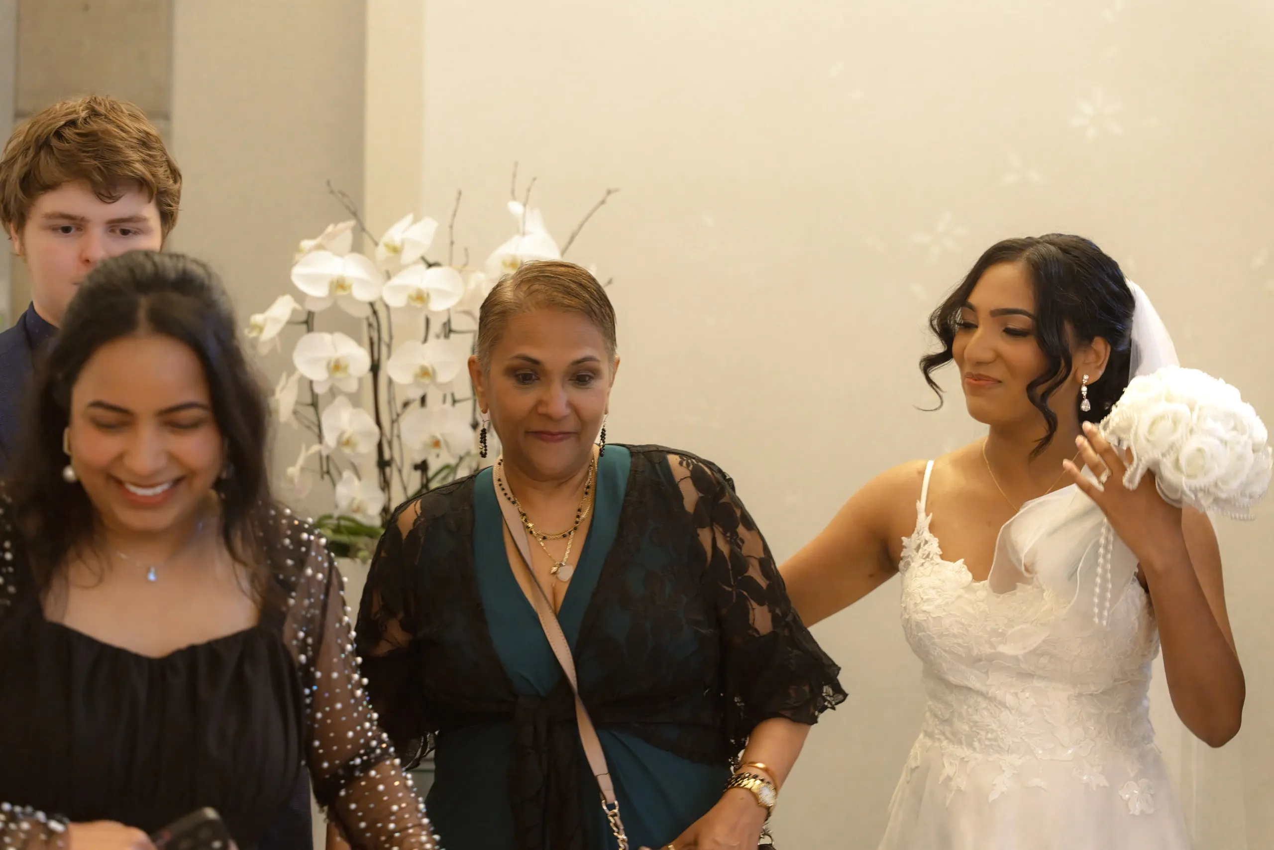 Bride walks out of the wedding chamber with her family, by AD Photography