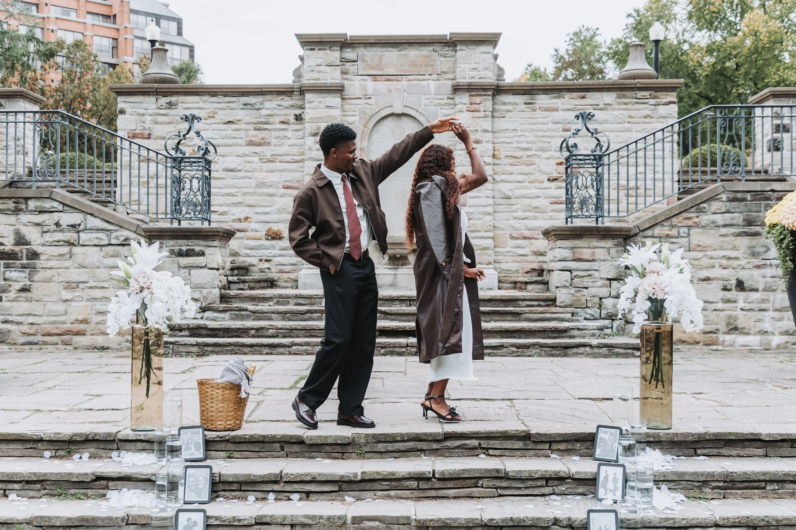 Richie twirling Aimee under his arm on the terrace landing between the lily vases, by AD Photography