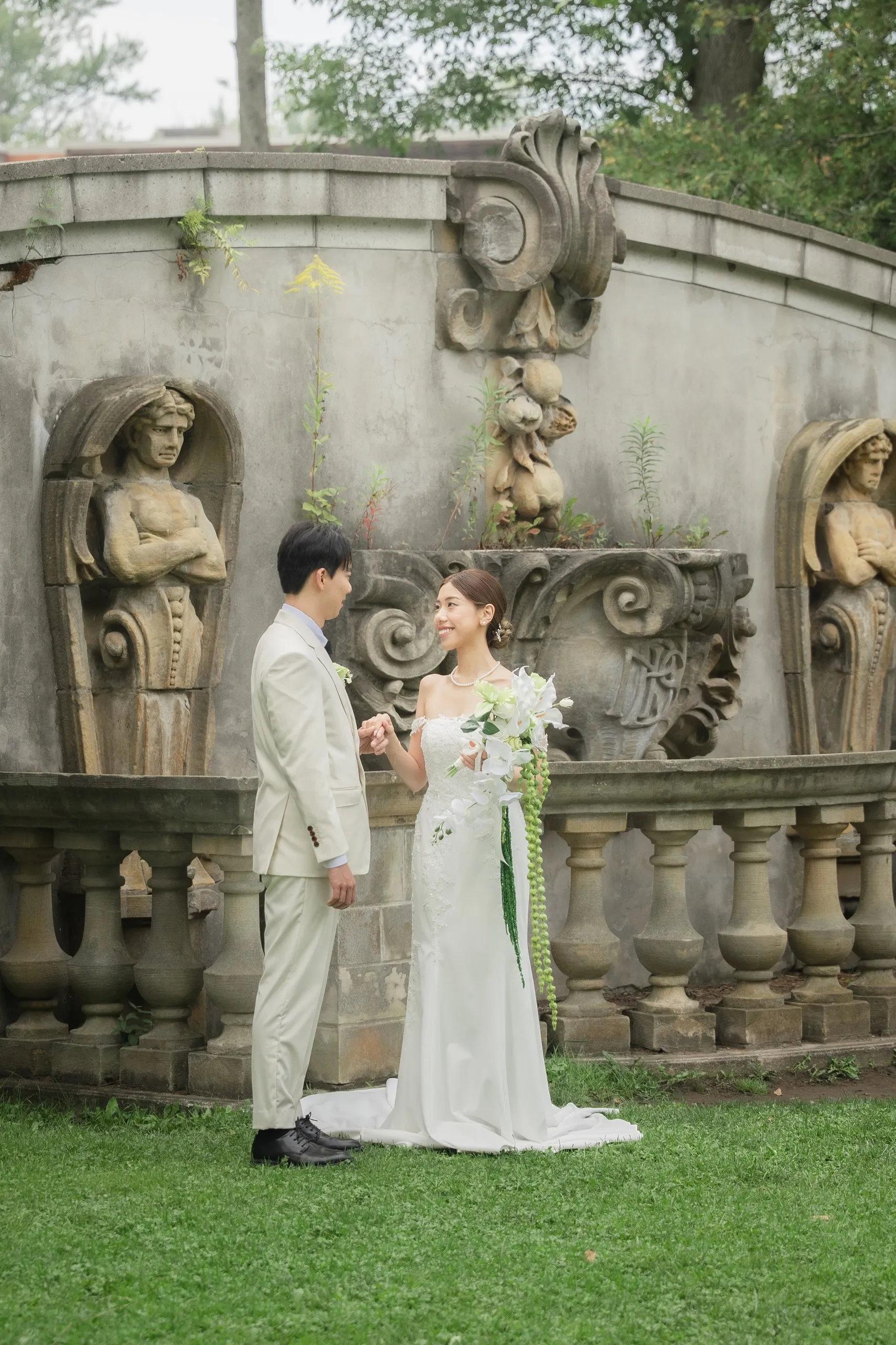 The couple hand in hand before the caryatid stone ruin at Guild Park, Scarborough, by AD Photography