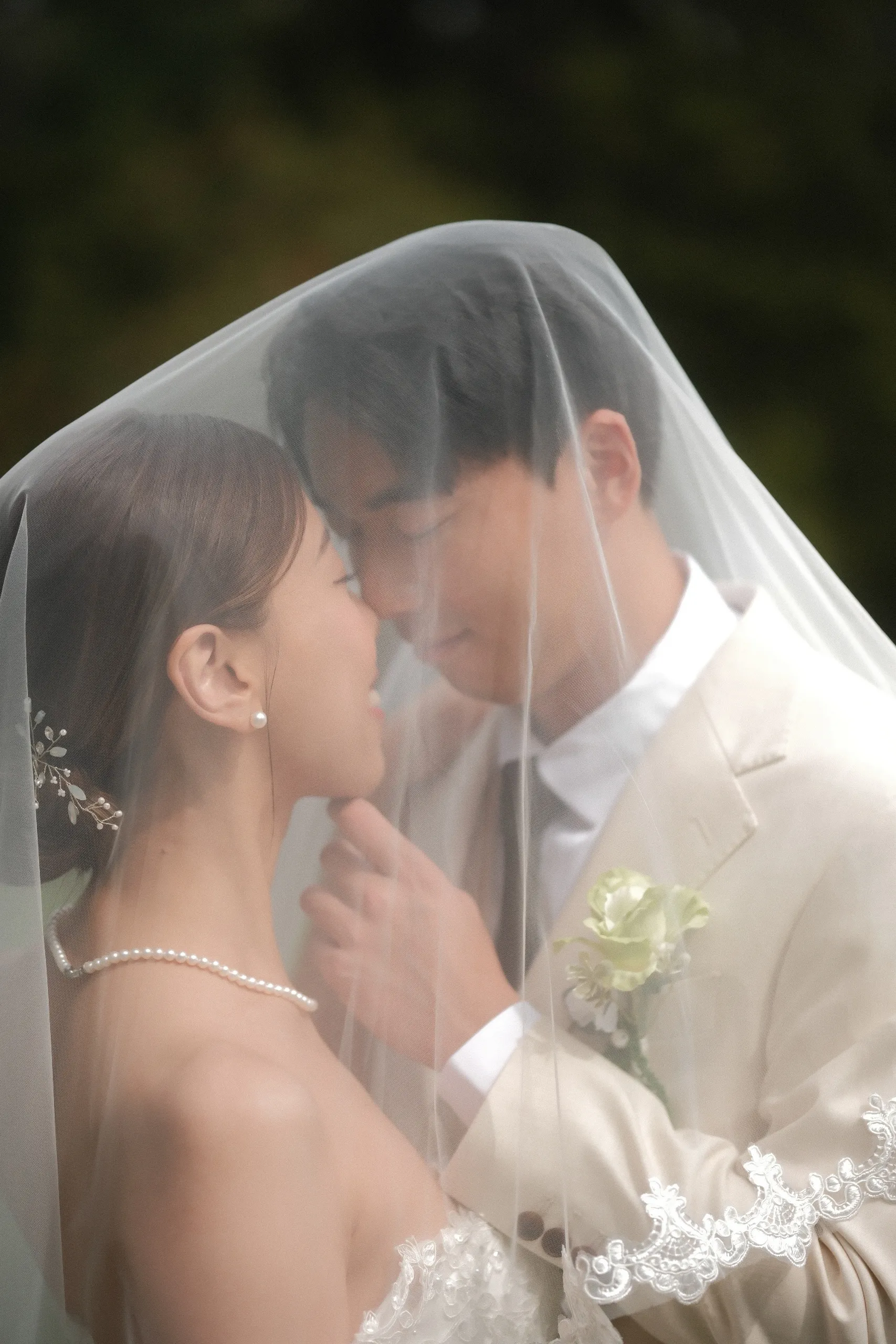 Soft focus through the veil, Josie and Nelson nose to nose on their wedding day, by AD Photography