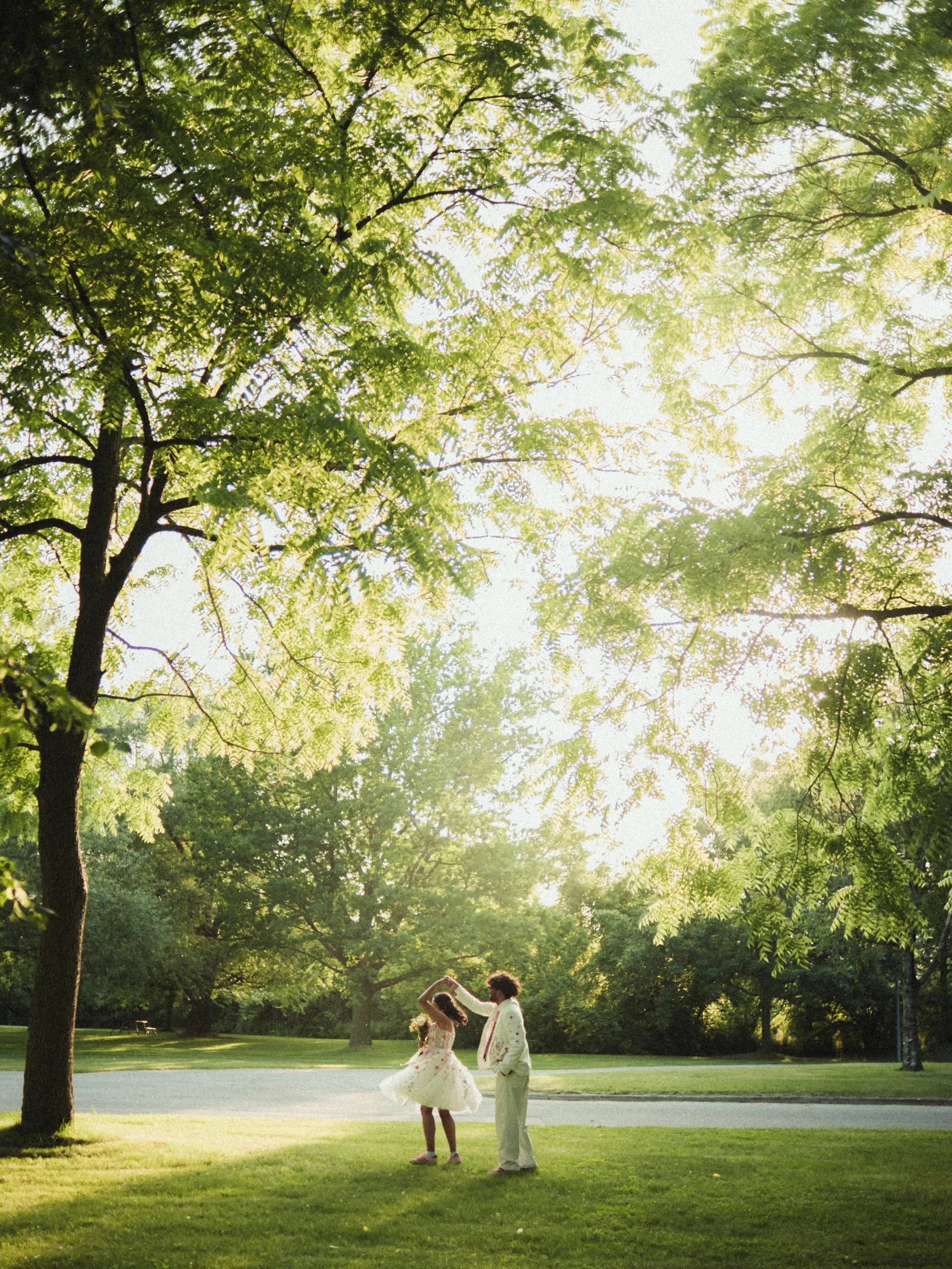 Payal twirling in backlight with her floral gown flaring, Toronto Islands, by AD Photography