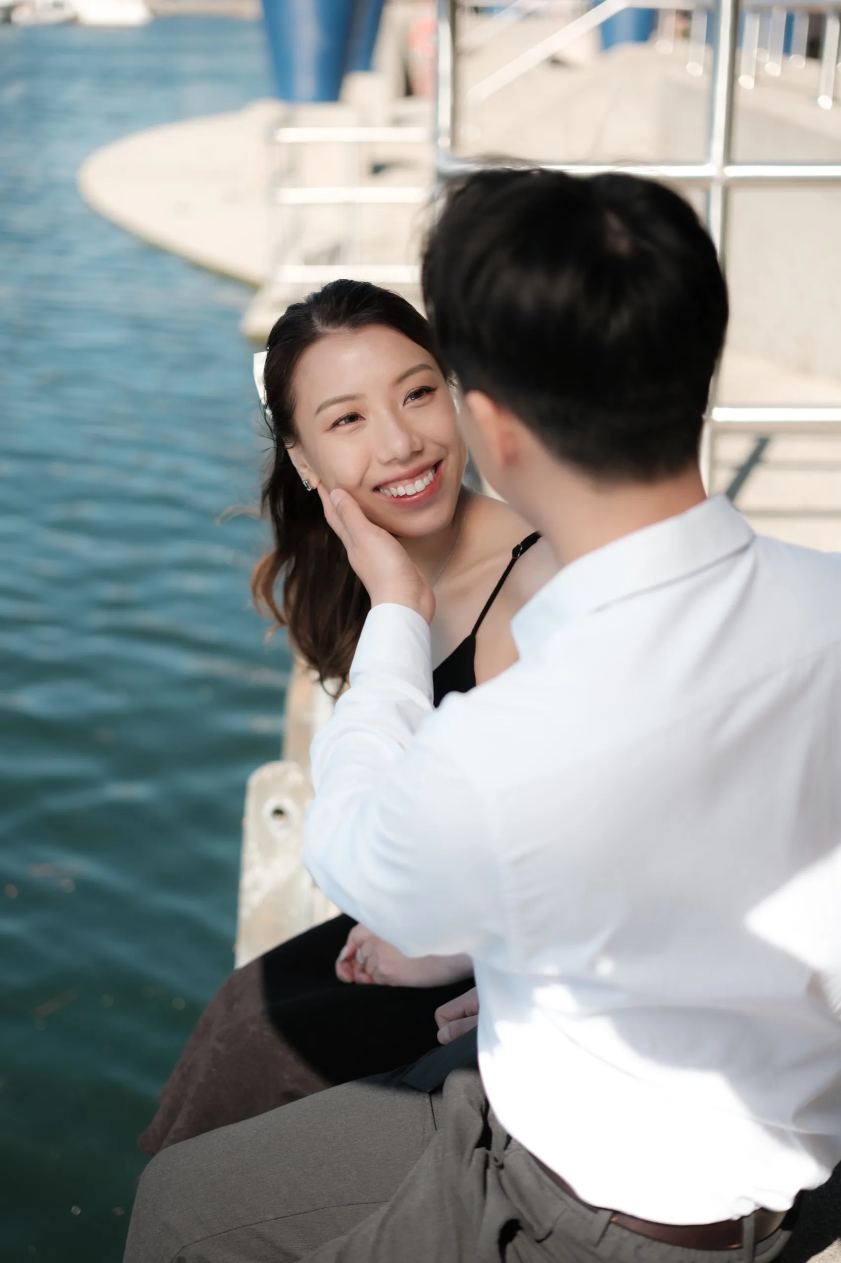 Josie cradles Nelson's face in a quiet moment at the edge of Lake Ontario, by AD Photography