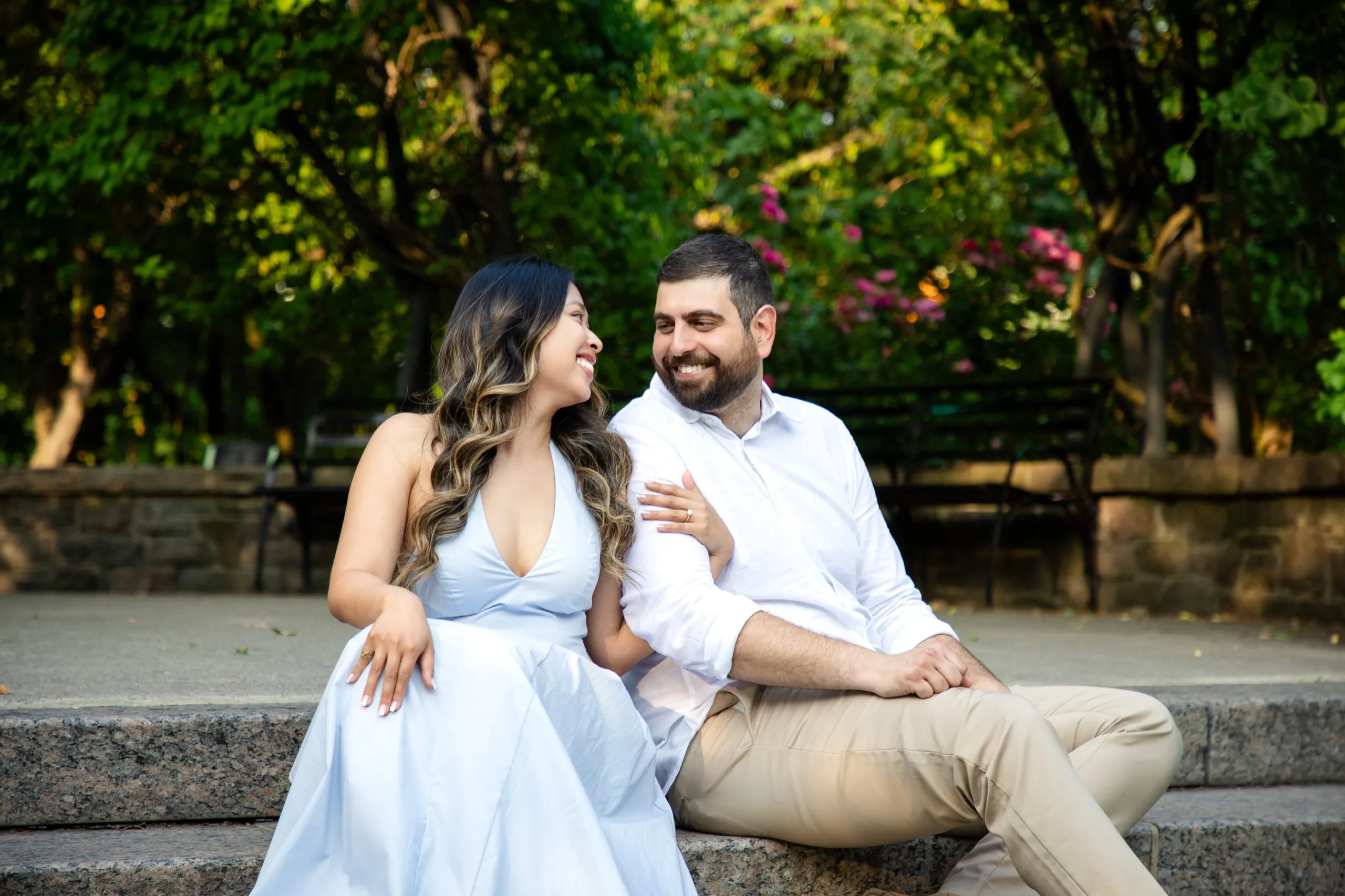 Margarita and Mike laughing together on the amphitheatre steps at the Toronto Music Garden, by AD Photography