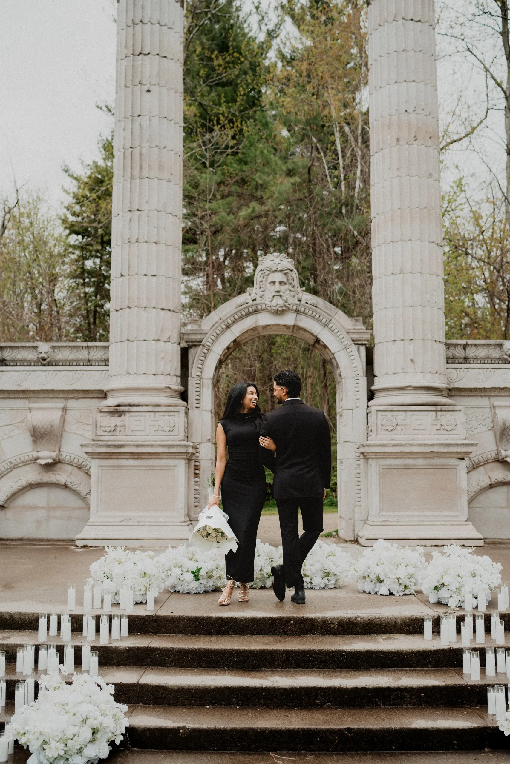 Lavina and Raeed walking up the candlelit steps at Guild Park and Gardens after saying yes, by AD Photography