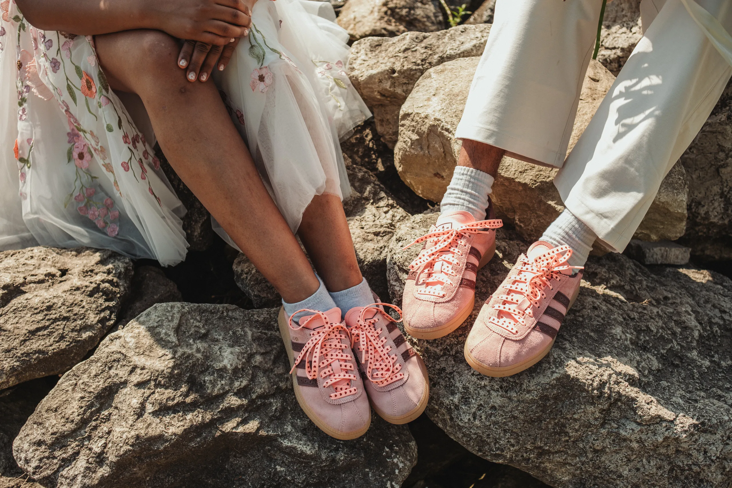 Detail of Harsh and Payal's matching pink sneakers side by side on the rocks, Toronto Islands, by AD Photography