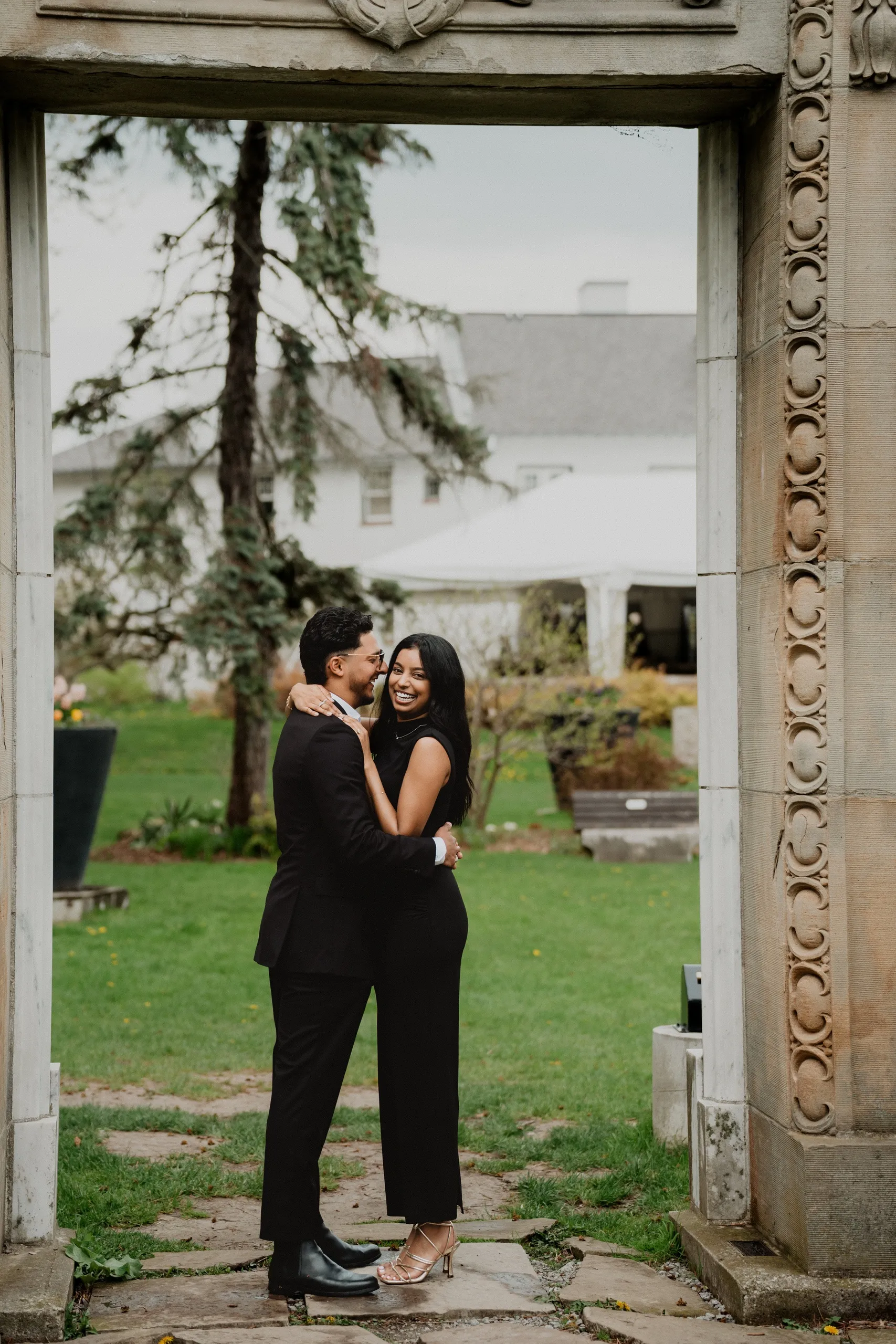 Raeed and Lavina embracing inside a salvaged stone doorway at Guild Park and Gardens, by AD Photography