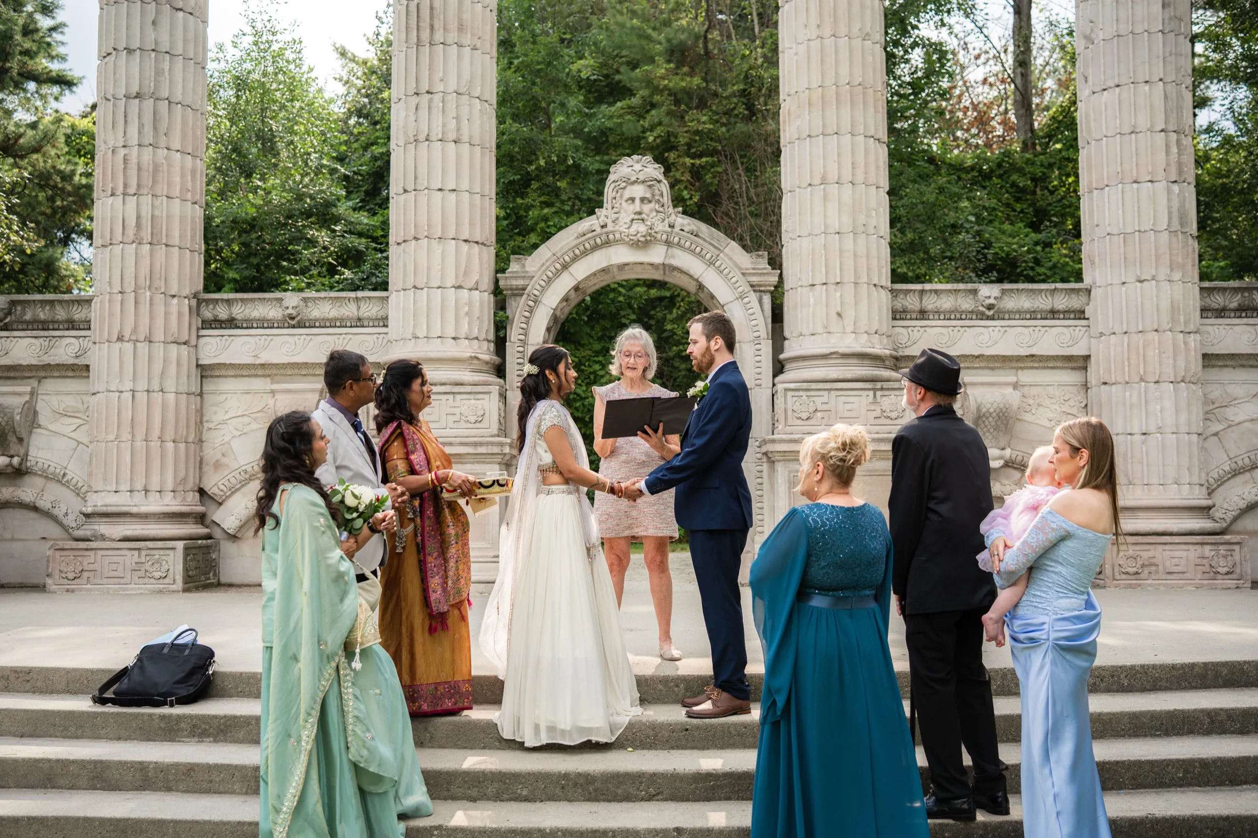 The wedding party gathers beneath the Greek Theatre arch for the civil ceremony vows., by AD Photography