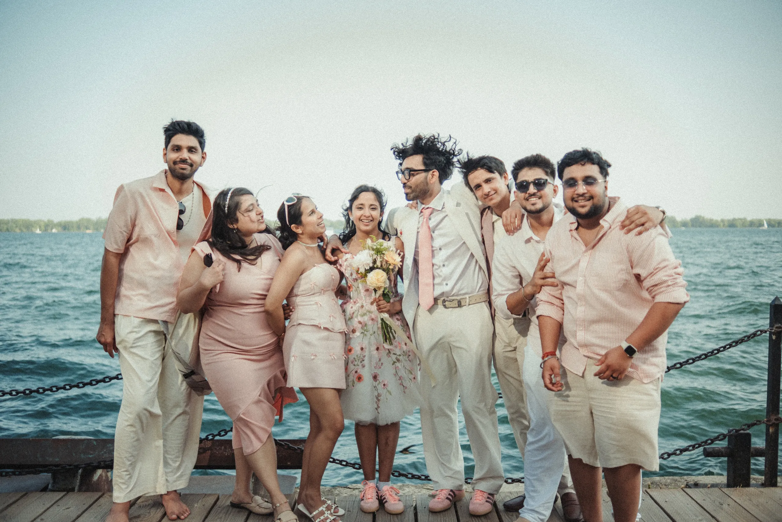 Harsh and Payal with their friends in coordinated blush outfits on the Toronto Islands pier, by AD Photography