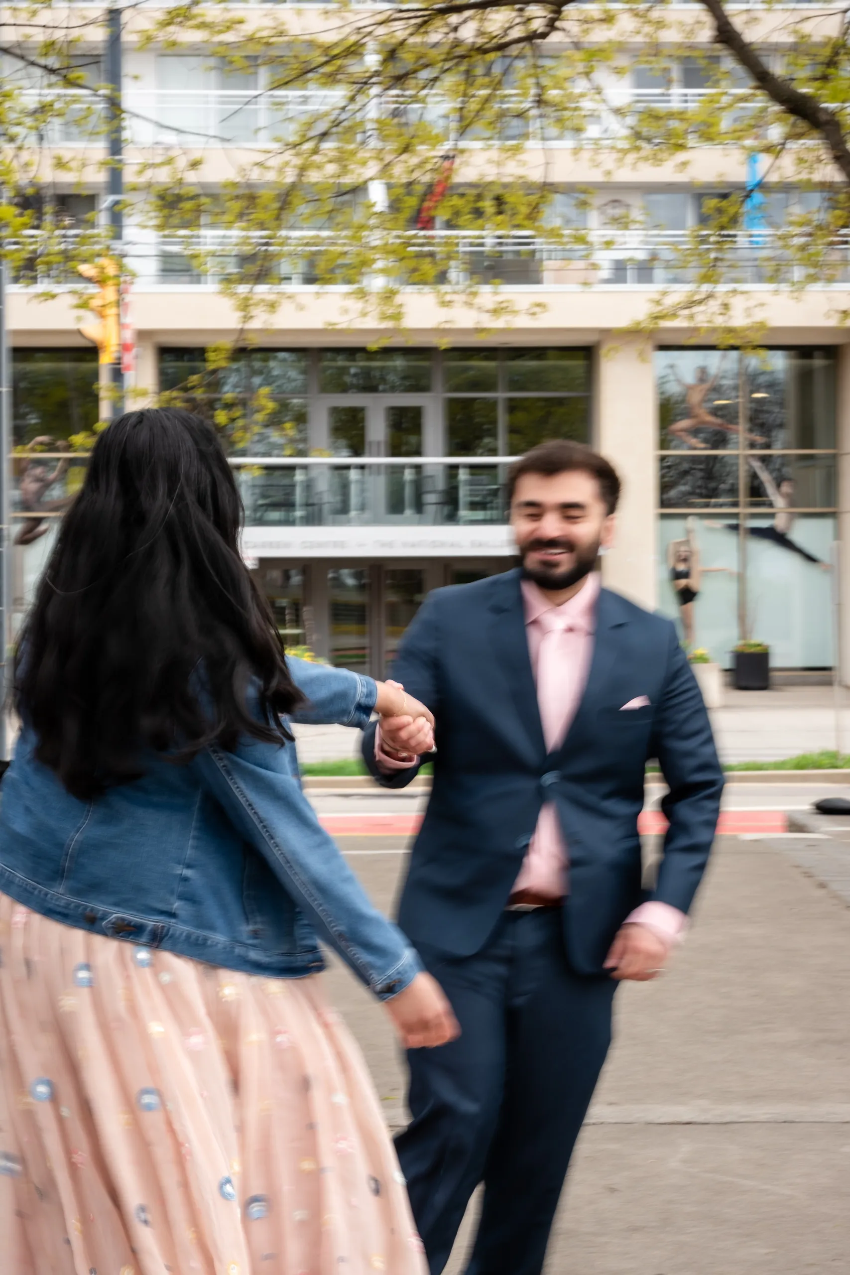 Nadia spins toward Abdullah in a motion blur frame outside the Toronto waterfront garden, by AD Photography