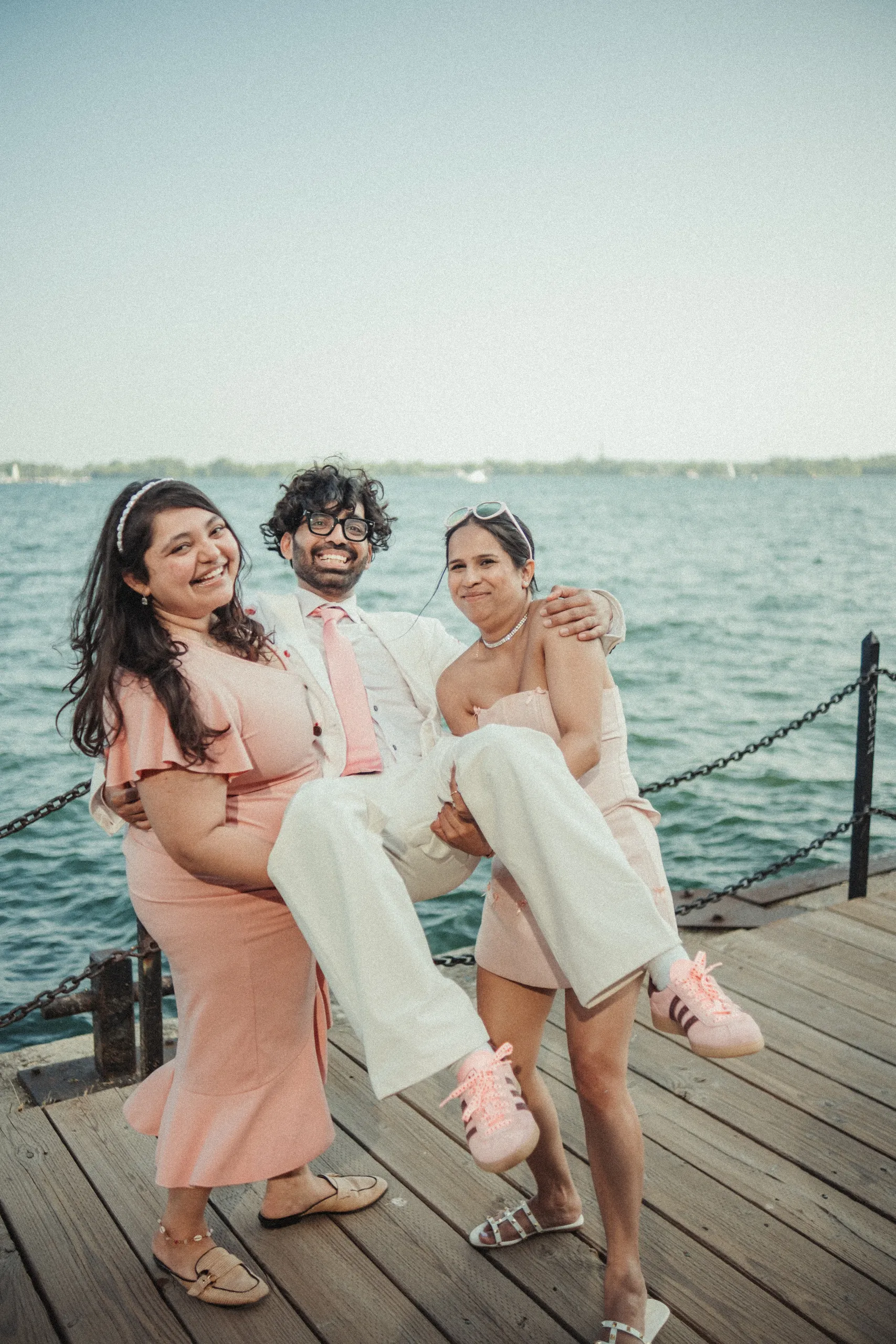 Harsh being carried by his friends, everyone laughing, on the Toronto Islands pier, by AD Photography