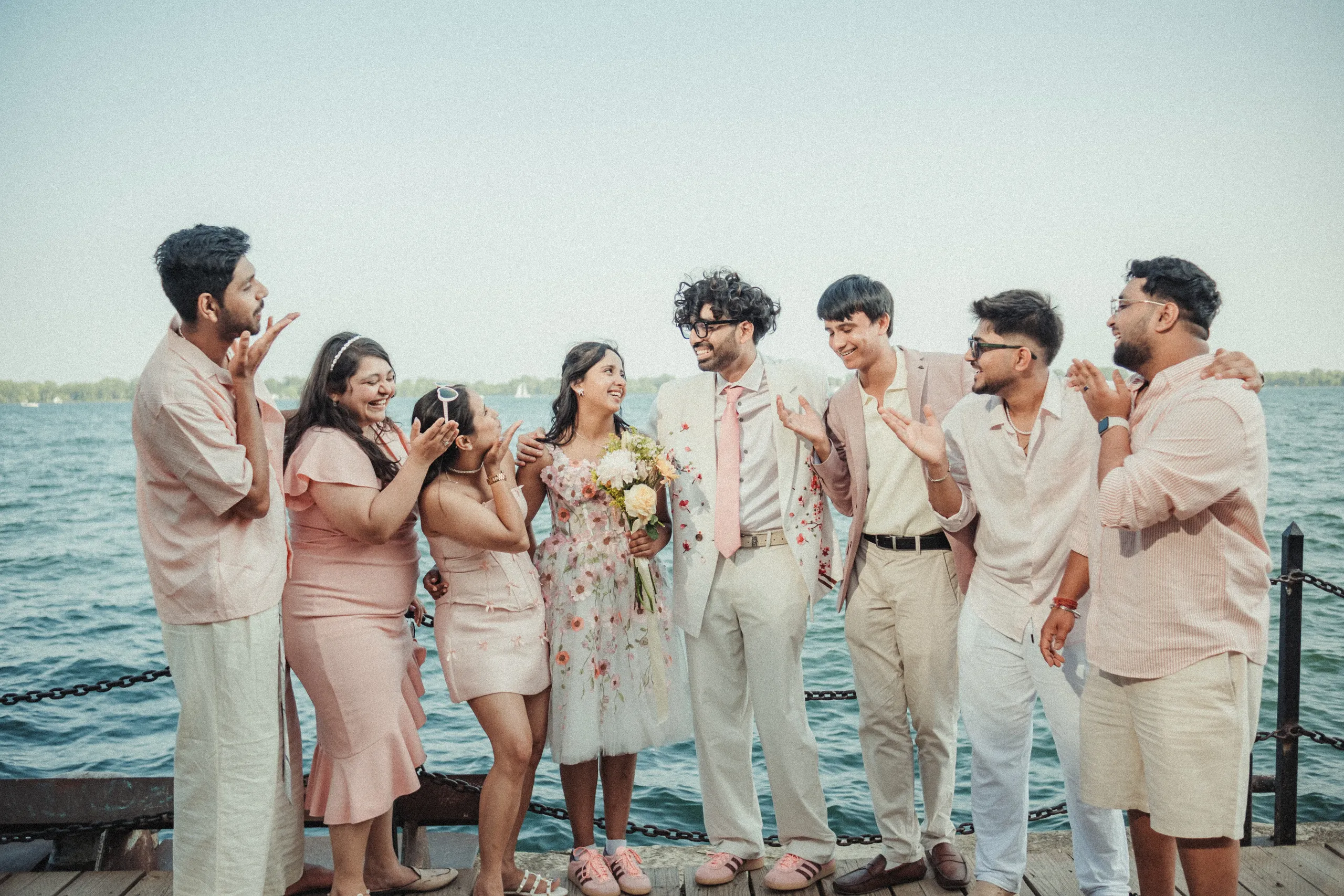 Friends lifting one of the bridesmaids on the pier at the Toronto Islands, by AD Photography