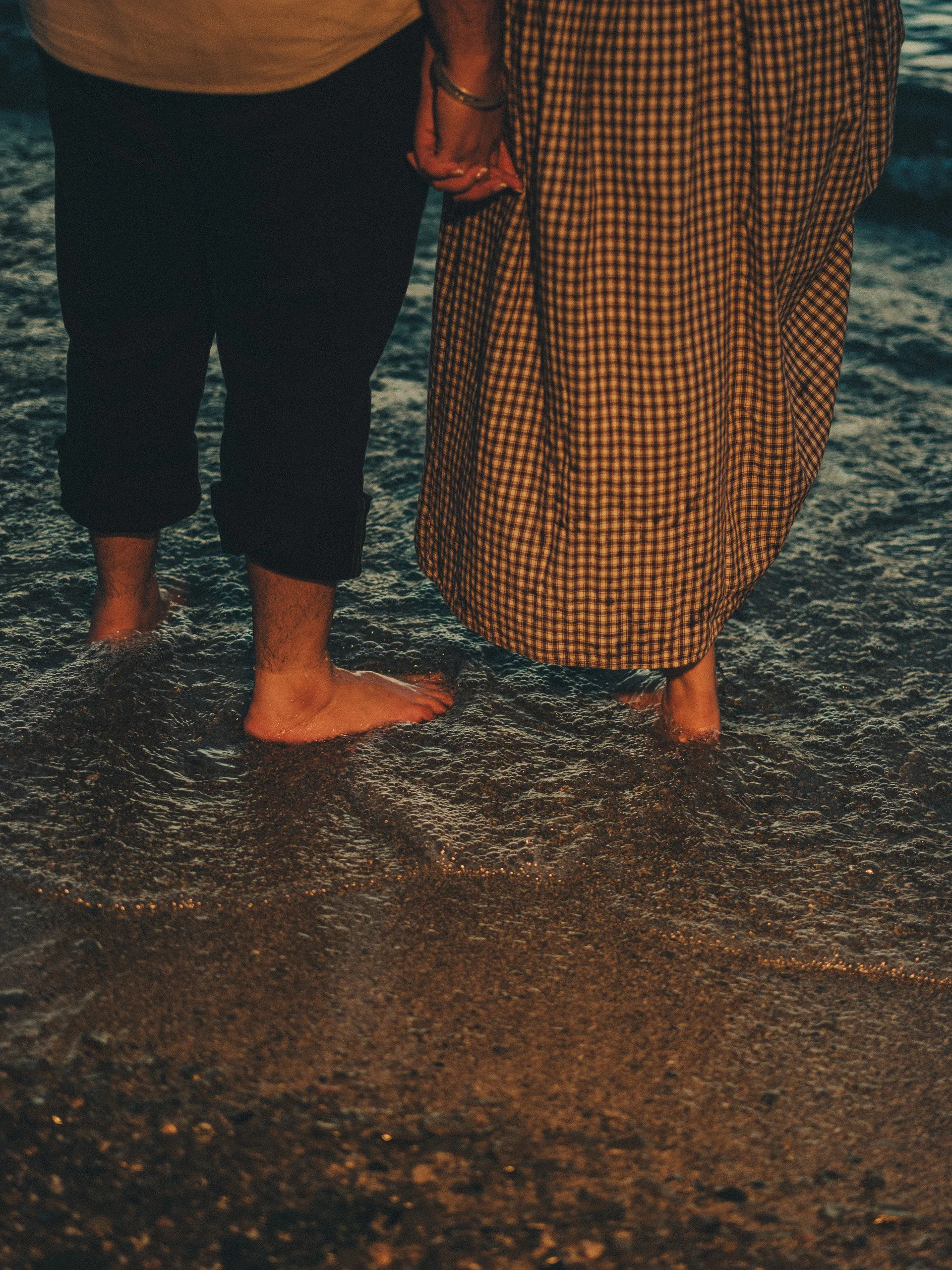 Bare feet in the morning wash, Maninder's rolled trousers beside the hem of Parneet's gingham dress, by AD Photography