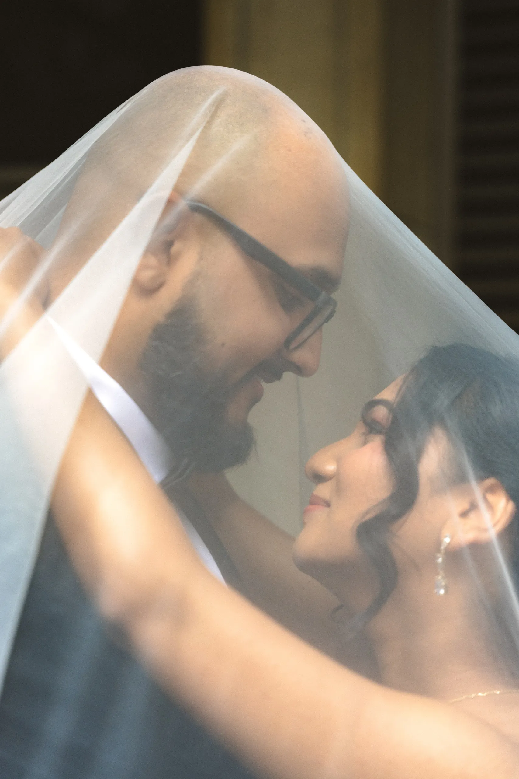Bride and groom under the cathedral veil at Toronto City Hall, by AD Photography