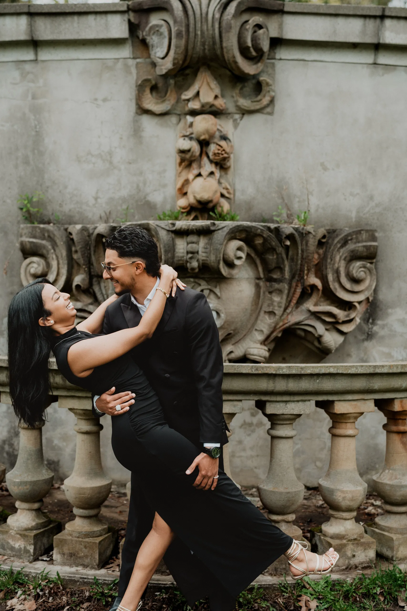 Raeed dipping Lavina in front of the carved stone balustrade at Guild Park and Gardens, by AD Photography