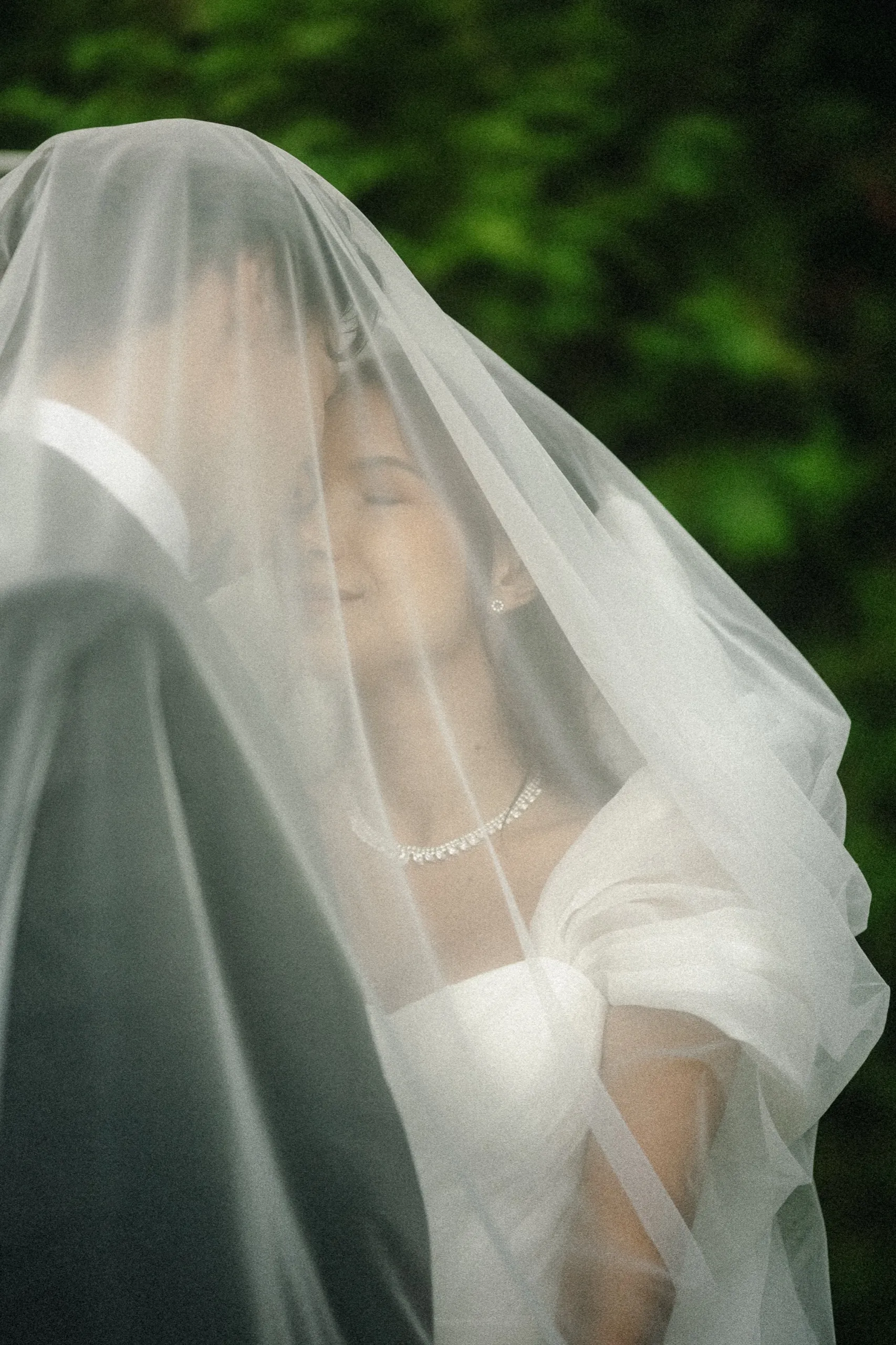 Kiss beneath the veil, photographed through the tulle, by AD Photography