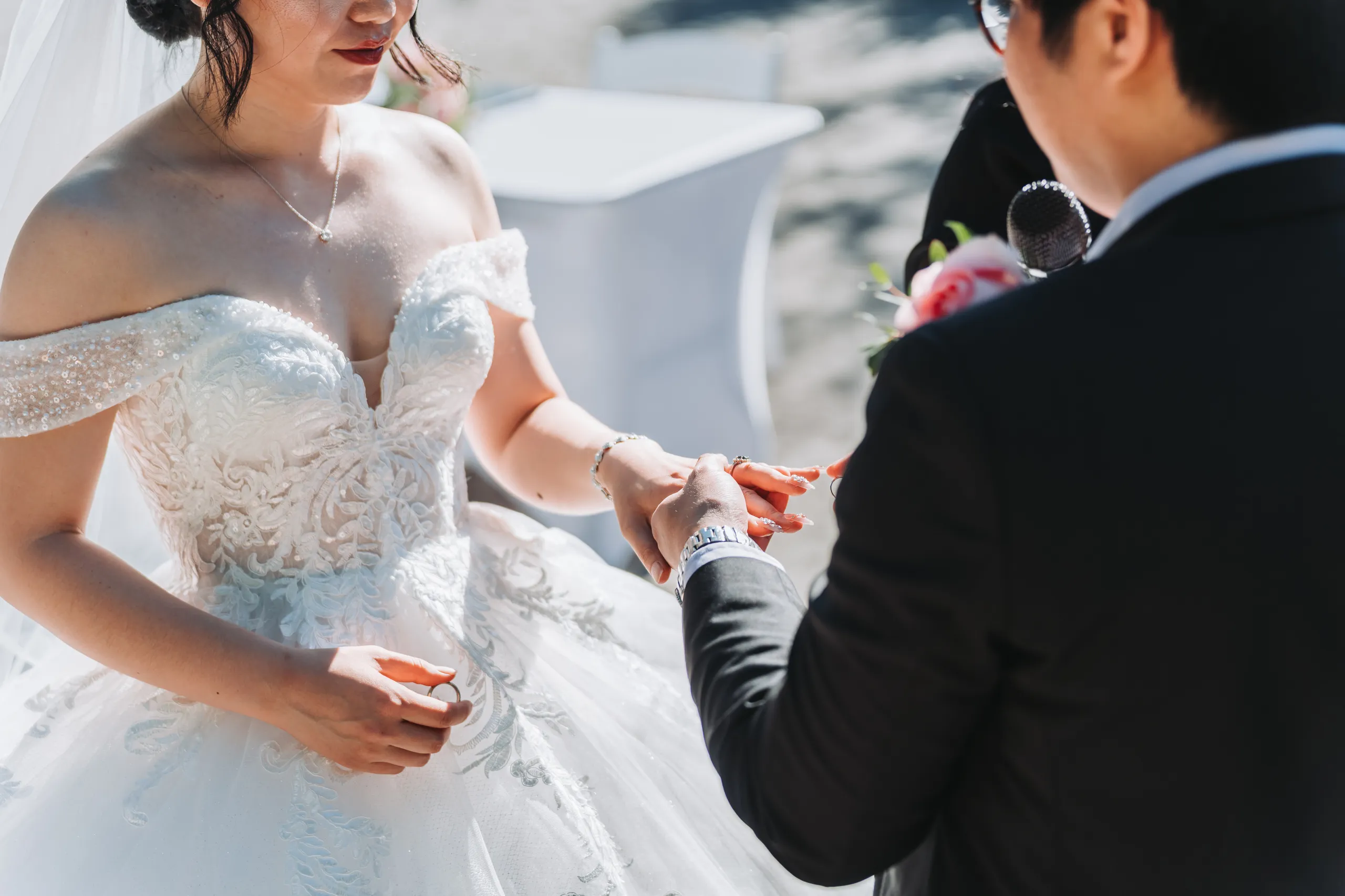 Close up of Micheal placing the ring on Karen's finger during their garden ceremony in Niagara Falls, by AD Photography