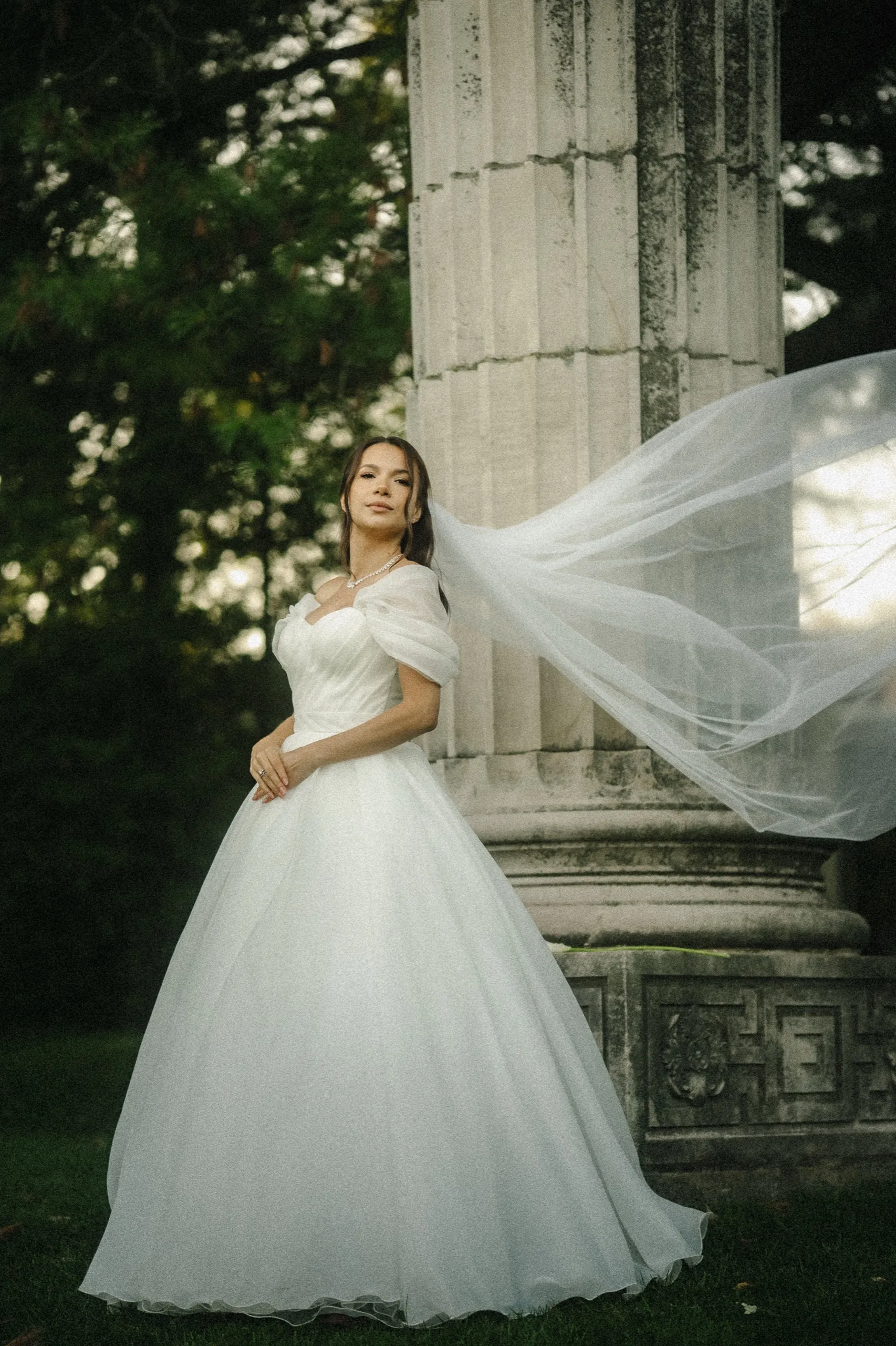 Veil flying beside a mossy fluted column on the lawn, by AD Photography