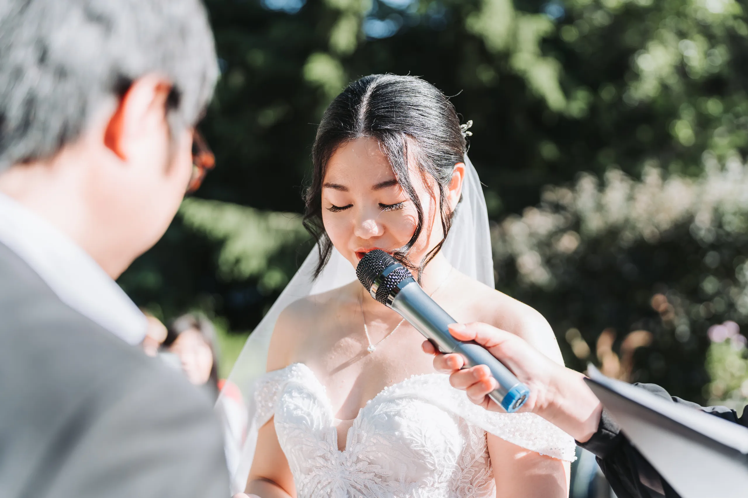 Karen reciting her vows with her eyes closed at the Niagara Parks Botanical Gardens, by AD Photography