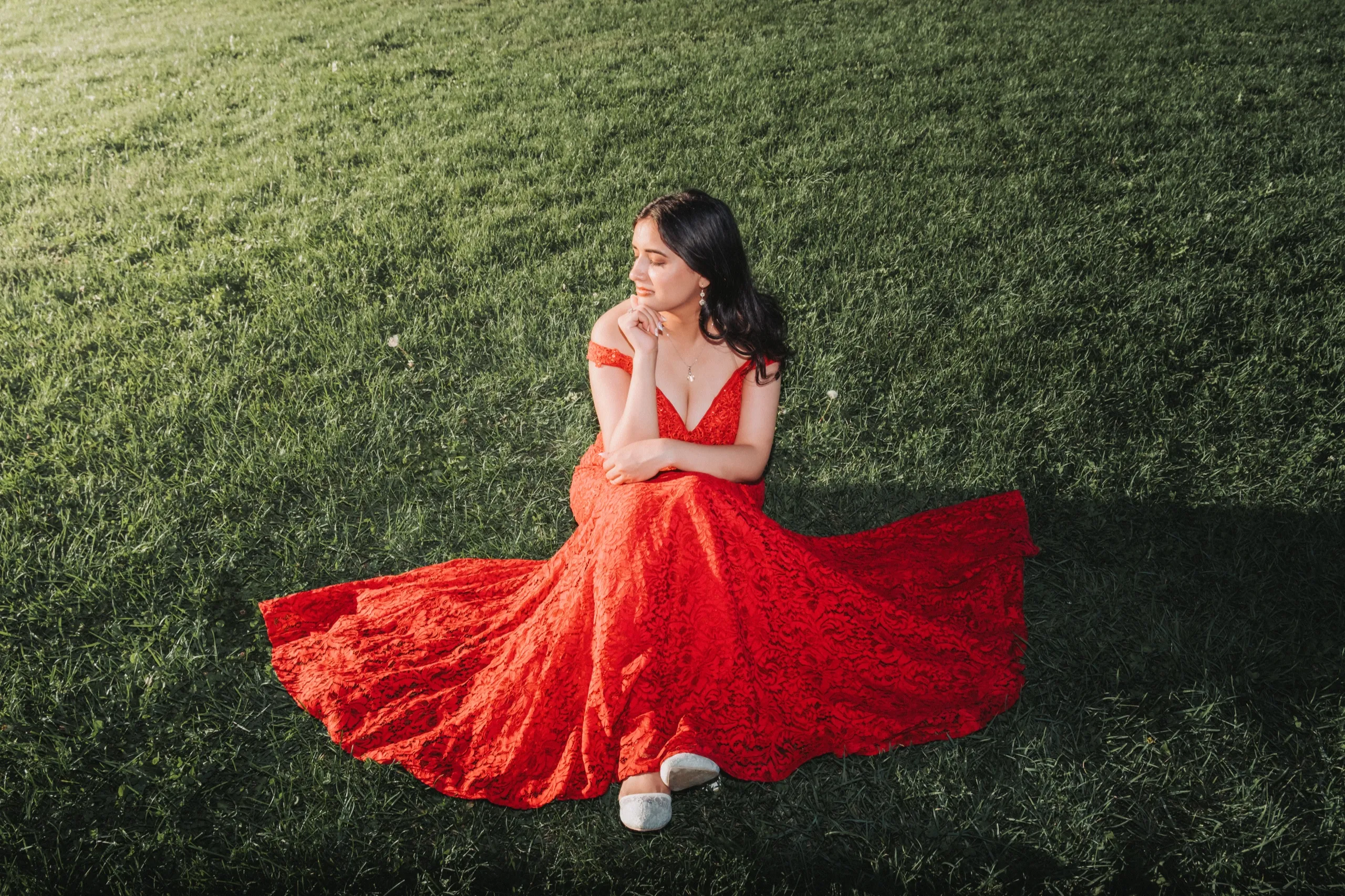 Overhead view of Swati's red gown fanned in a full circle on the lawn, by AD Photography