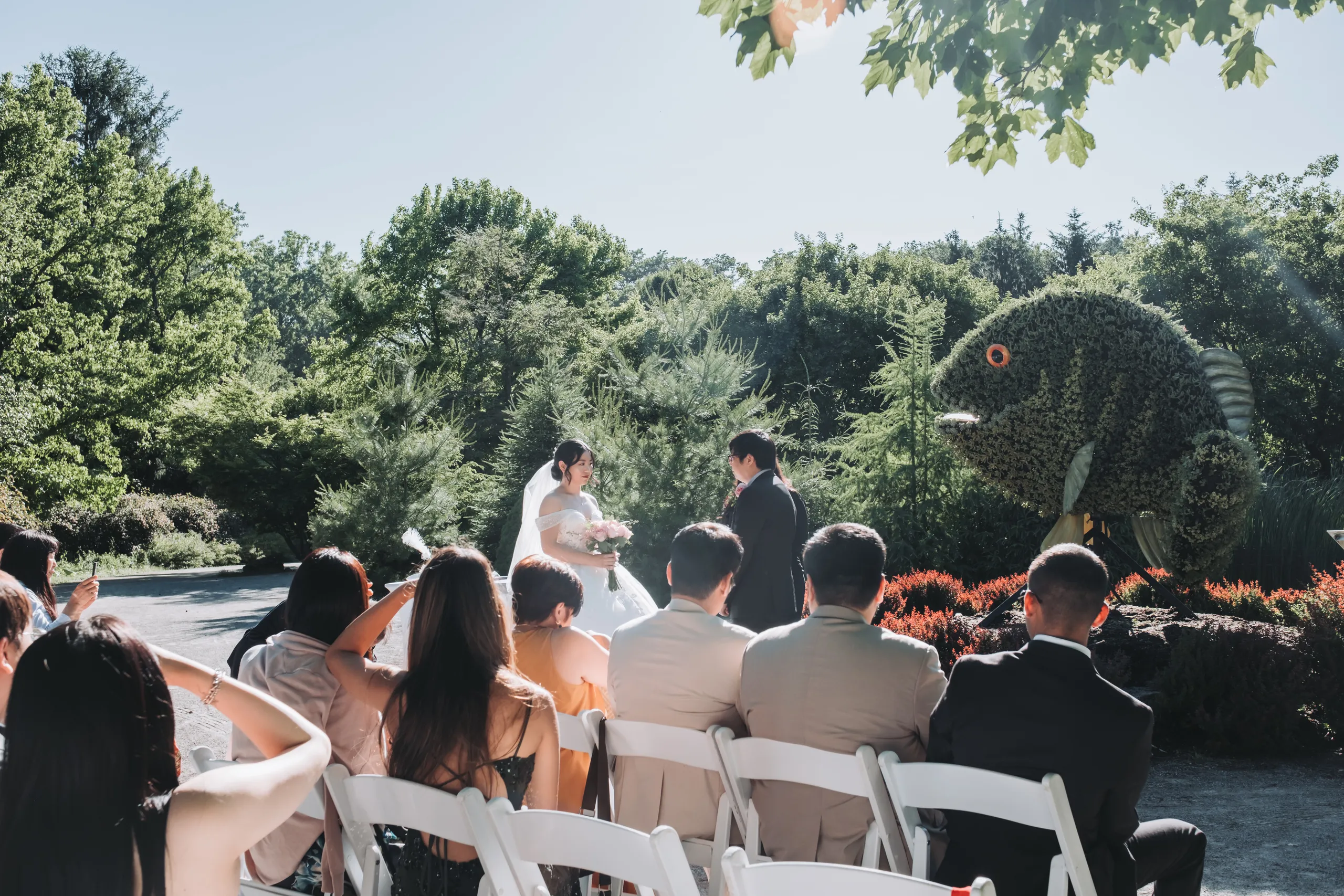 Guests reacting from their seats as Karen and Micheal marry beside the fish topiary in Niagara Falls, by AD Photography