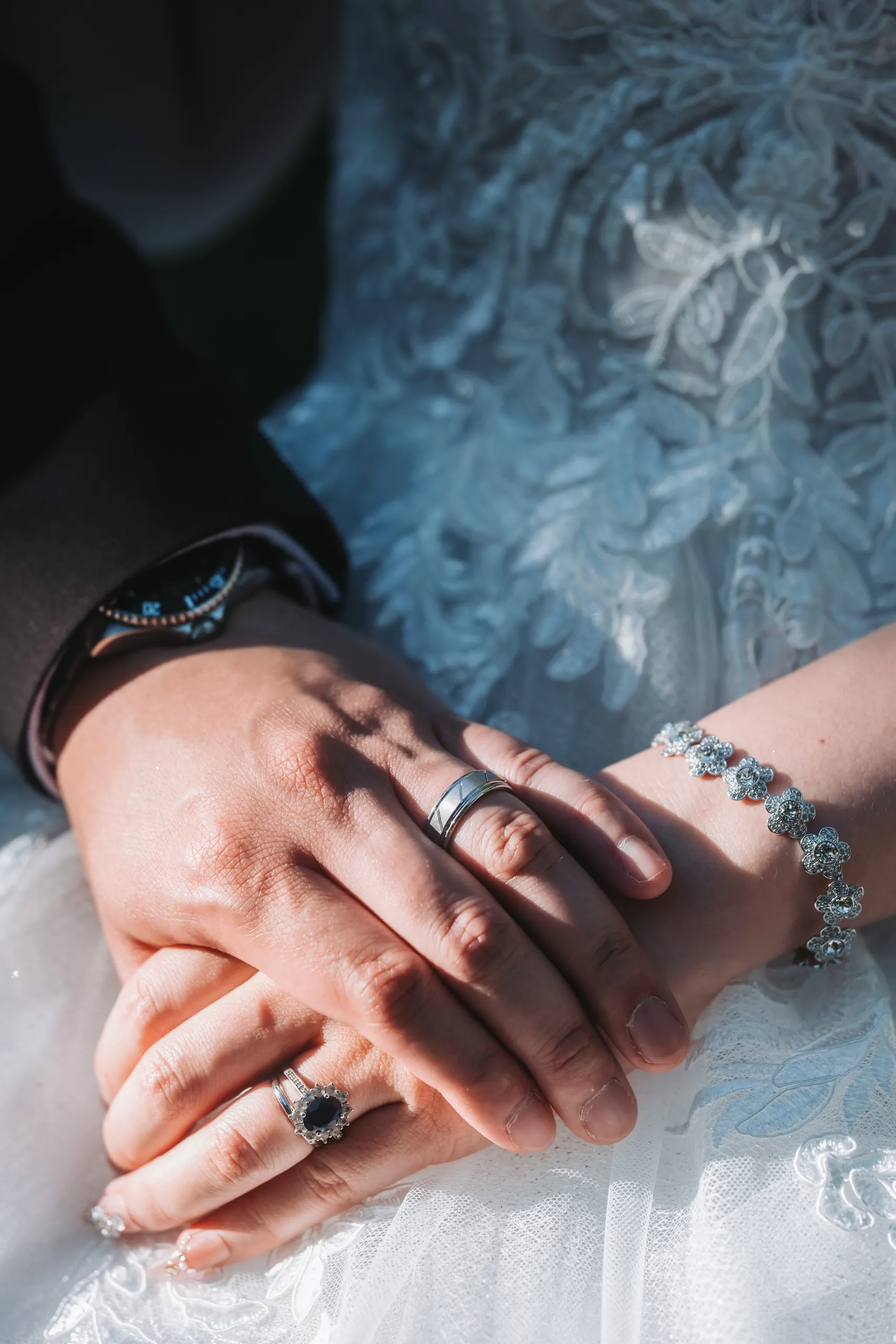 Karen and Micheal's interlaced hands showing both wedding rings after the ceremony, by AD Photography