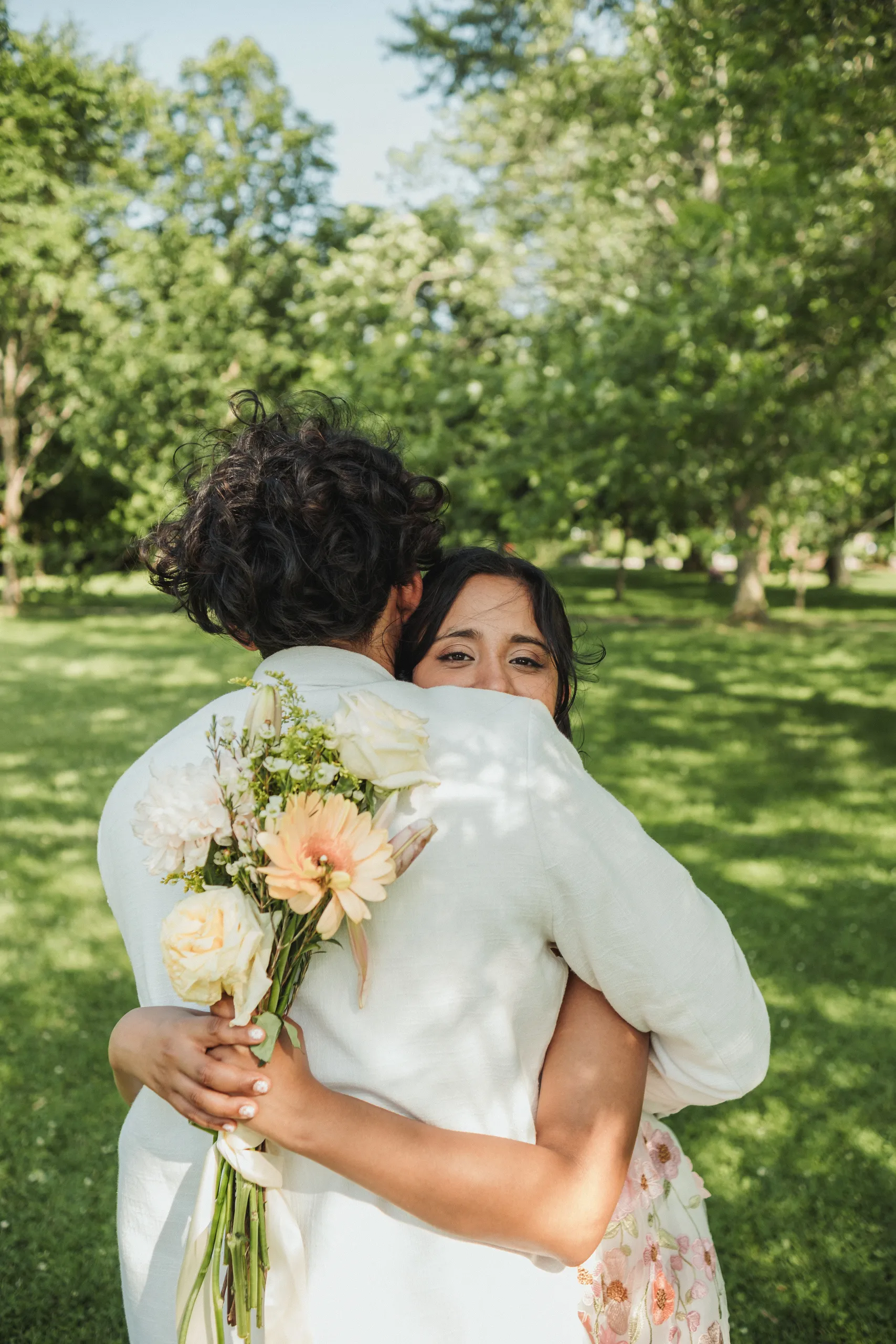 Payal resting against Harsh with a soft smile on the Toronto Islands, by AD Photography