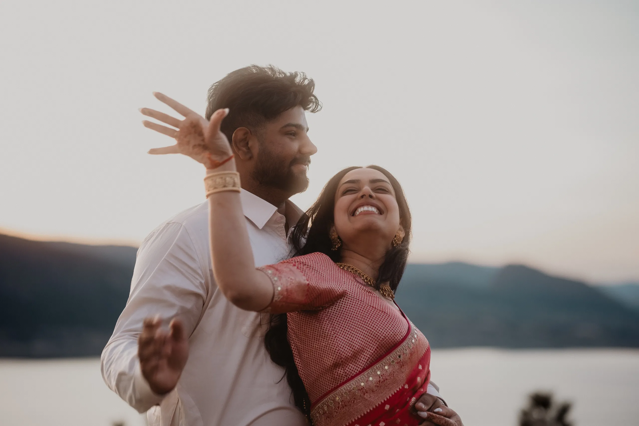 Mehak laughing with her bangled hand raised as Kamal holds her at dusk, by AD Photography