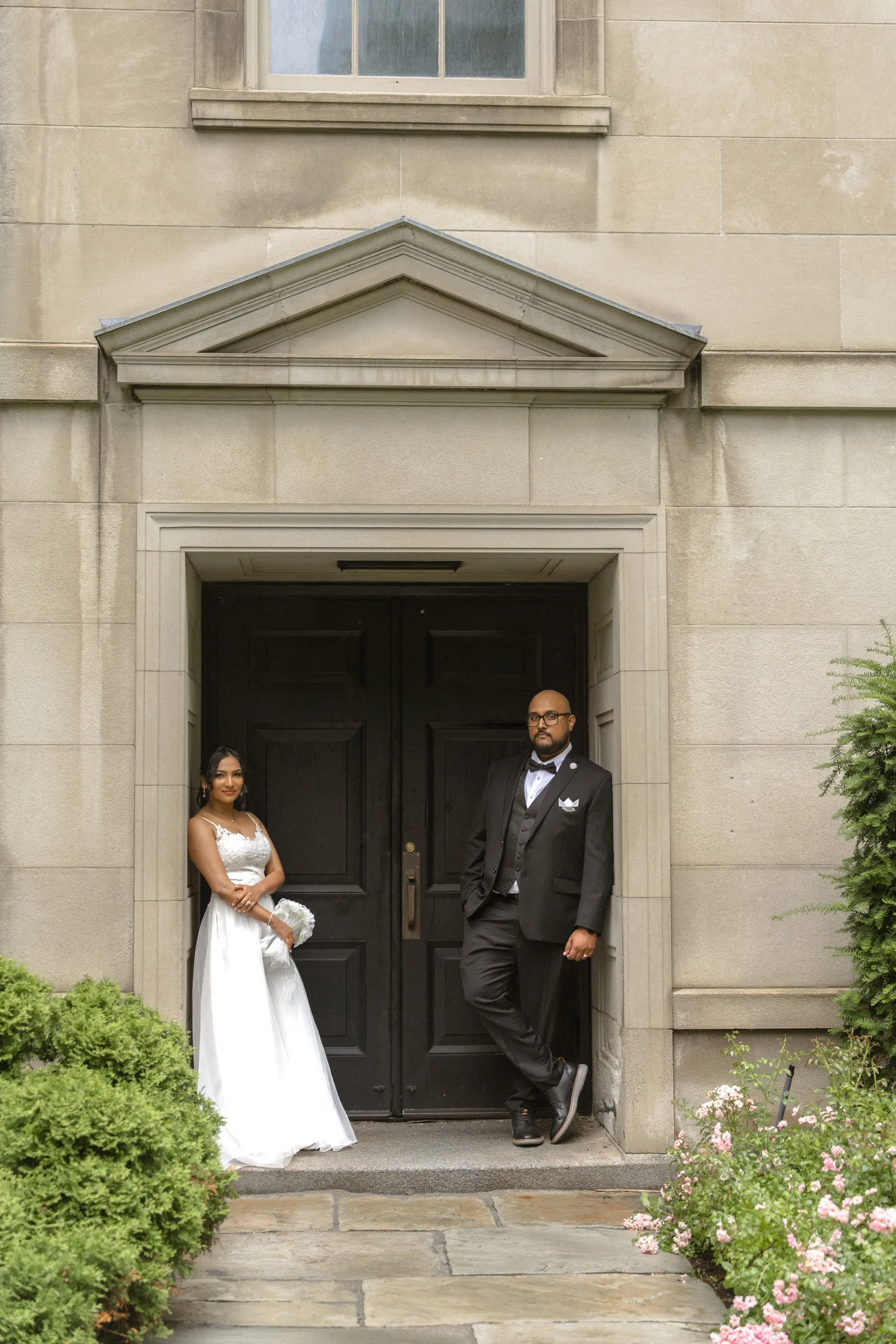 Bride and groom framed in a stone doorway at Osgoode Hall, by AD Photography