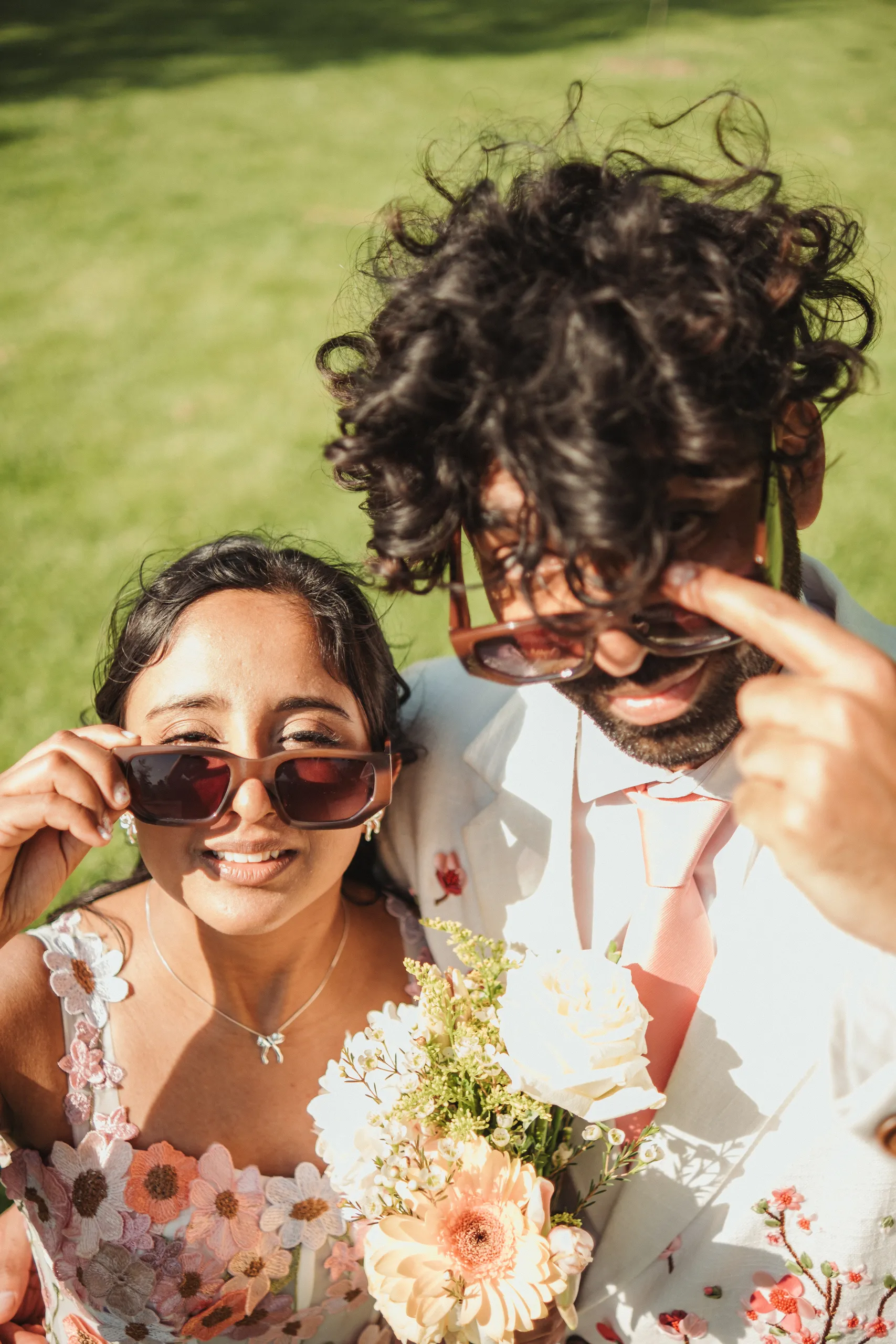 Harsh pointing at their shadows while Payal laughs, both in sunglasses, Toronto Islands, by AD Photography